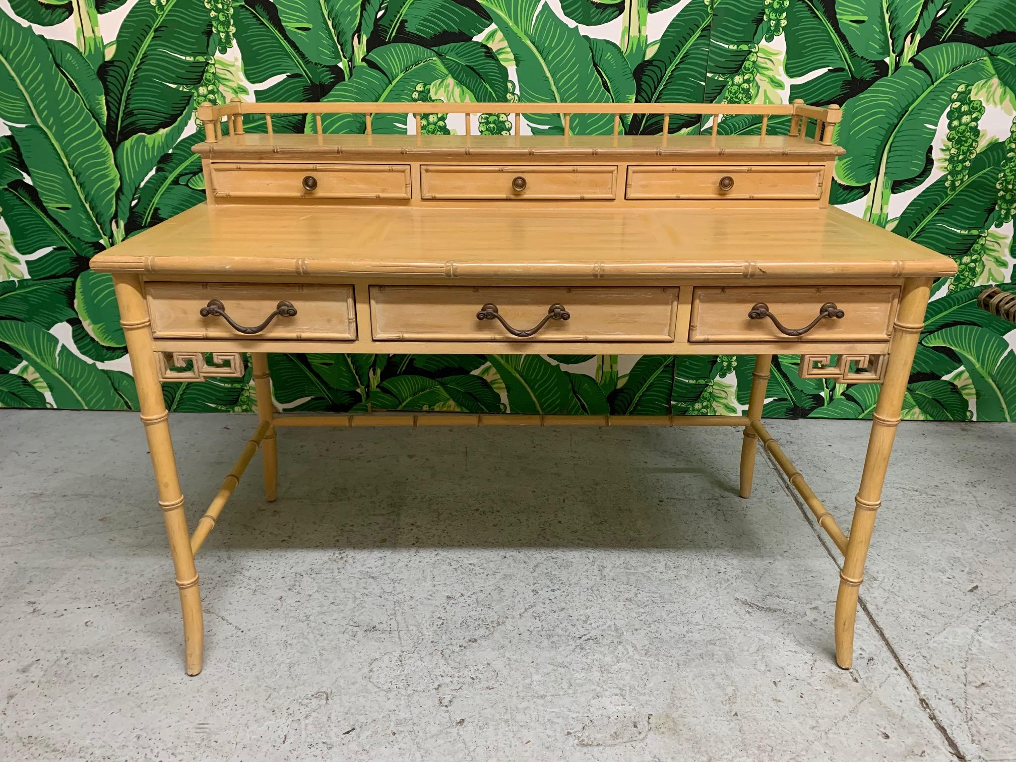 Midcentury writing desk designed by Raymond Sobota for Century Furniture features faux bamboo detailing with Greek key accents and a cerused finish. Solid wood construction. Good condition with only minor imperfections consistent with age.