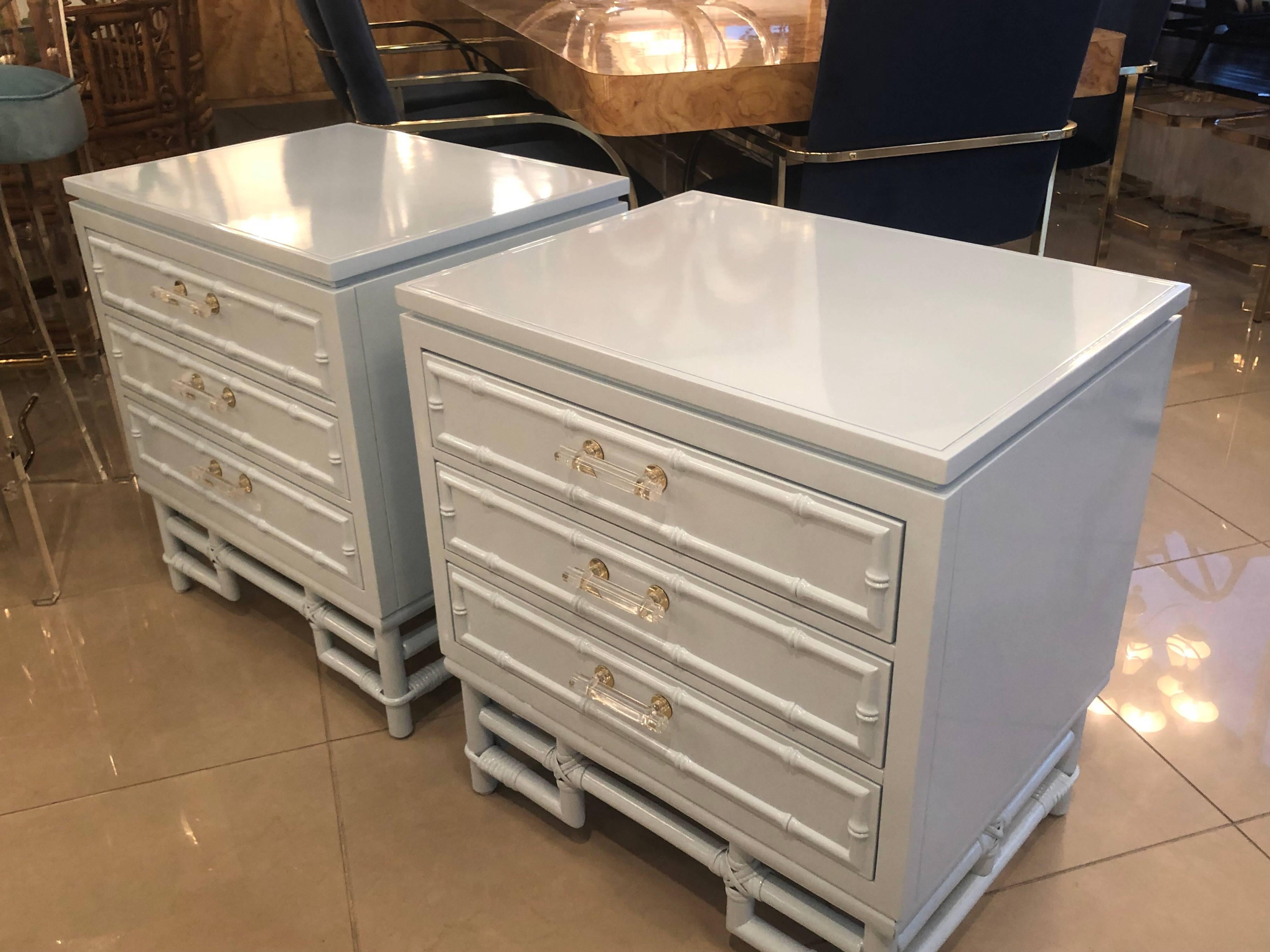 The most amazing pair of vintage faux bamboo nightstands nightstands. These have been professionally restored. Newly lacquered in the softest powder blue, including inside the drawers. Vintage custom Lucite and brass hardware has been added to put