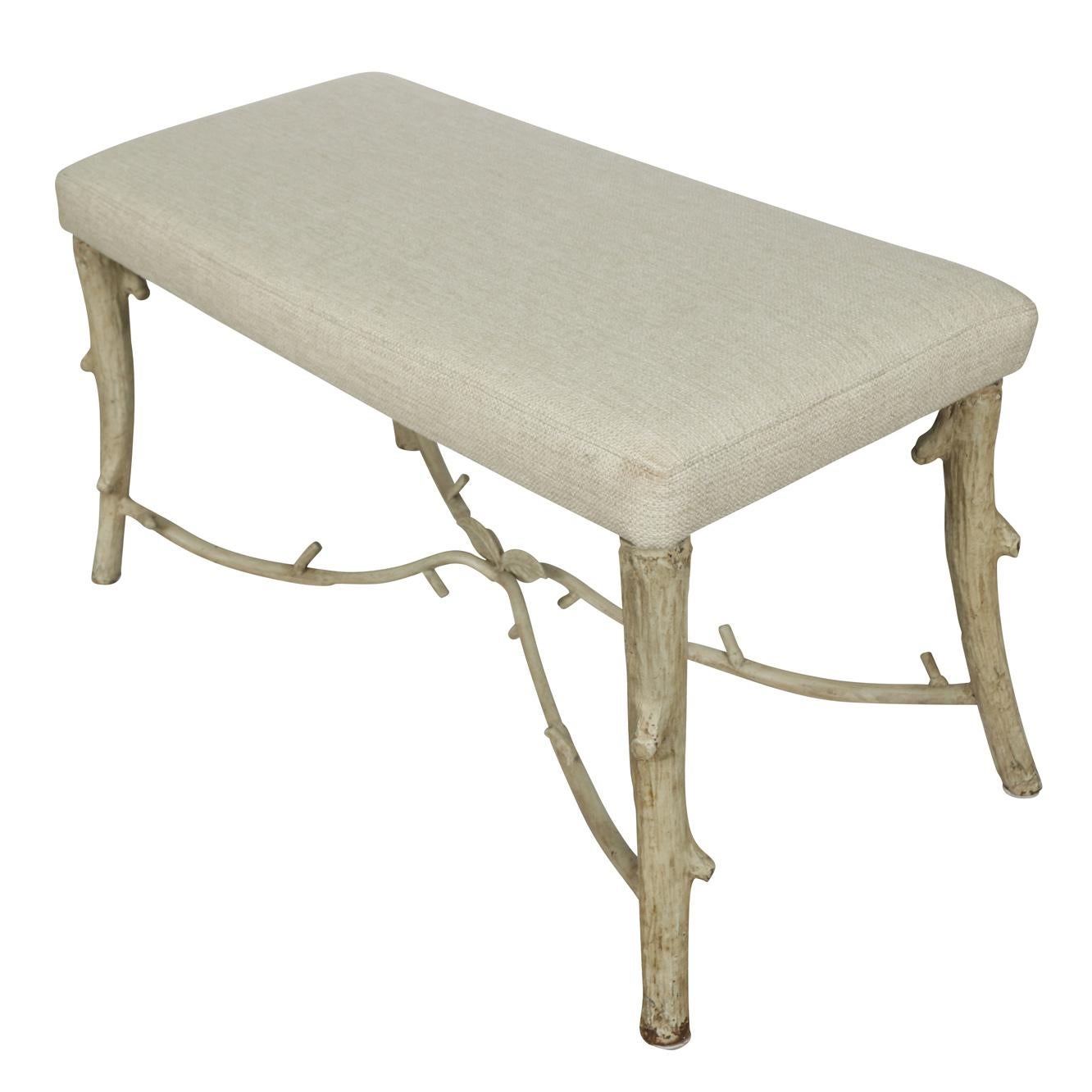 We love the whimsy of this small bench. The linen covered seat is supported by a painted metal faux bois base forming a lovely cross stretcher adorned with leaves.