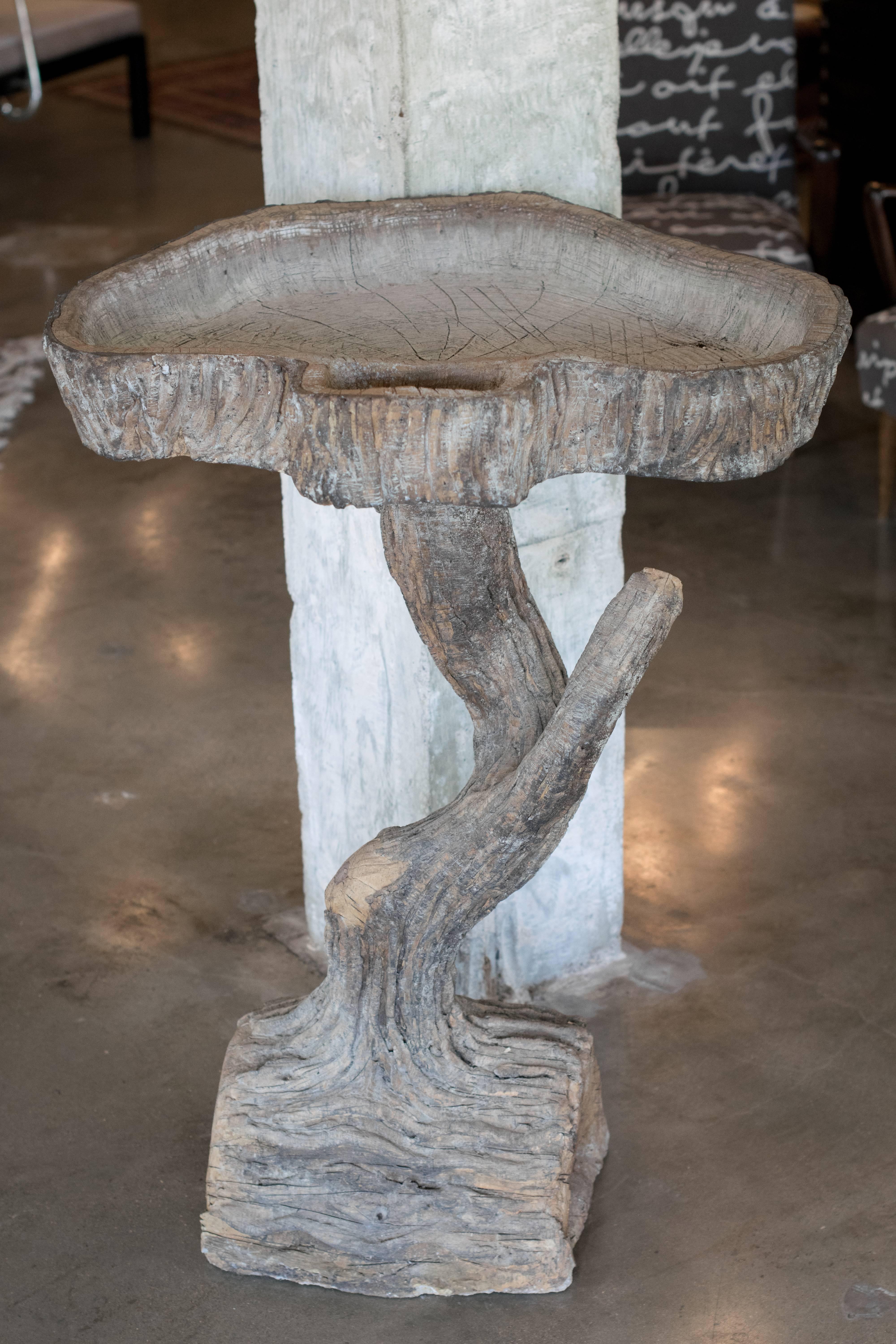 Sculptor Rene Romero of San Antonio, Texas learned the art of faux bois from famed master artisan Carlos Cortes. Signed by Romero, this sculpted concrete stand serves decoratively in an interior or within the garden as a birdbath. There is a smaller