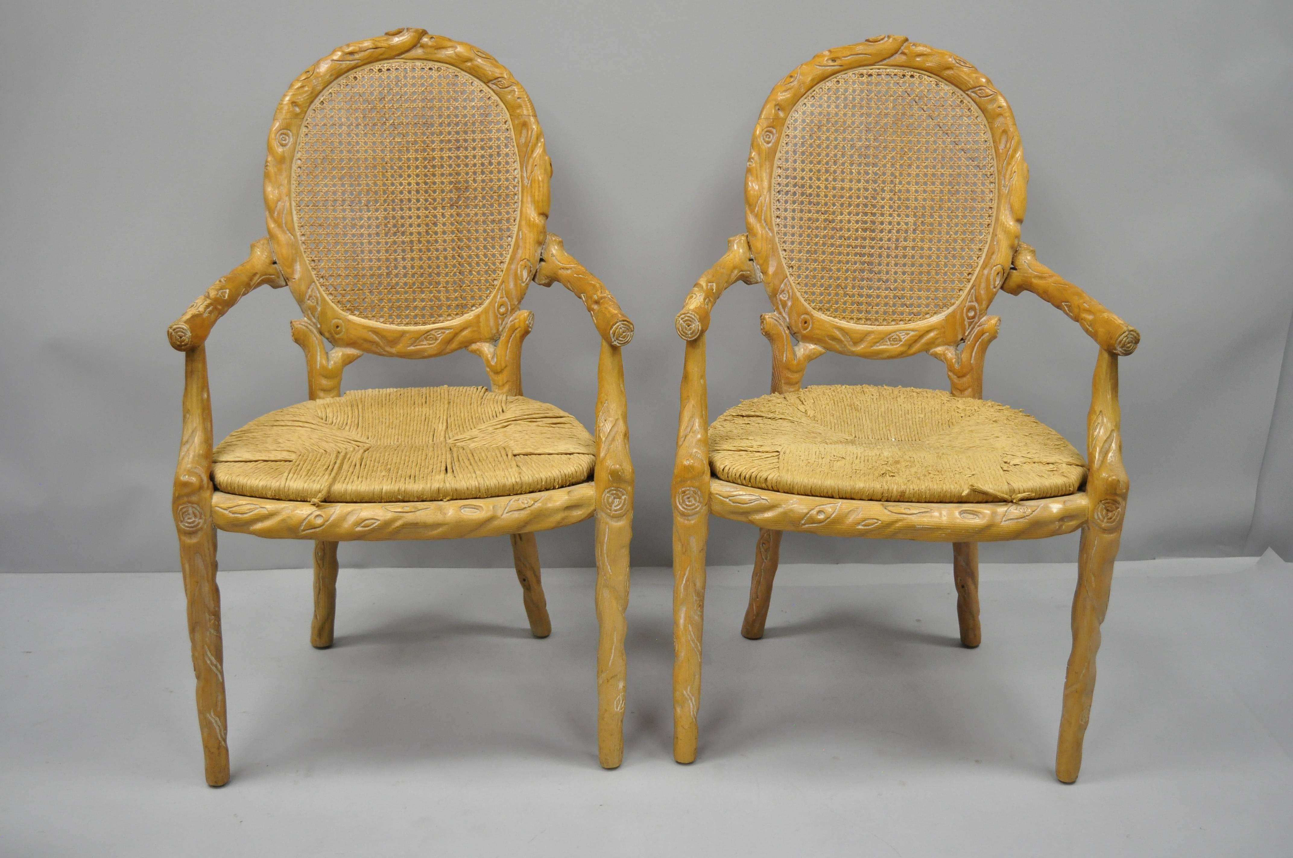 Set of six vintage Faux Bois rush seat dining chairs. Listing includes two armchairs and four side chairs. Item features heavy solid wood construction, nicely carved details, tapered legs, oval cane backs, woven rush seats, quality American