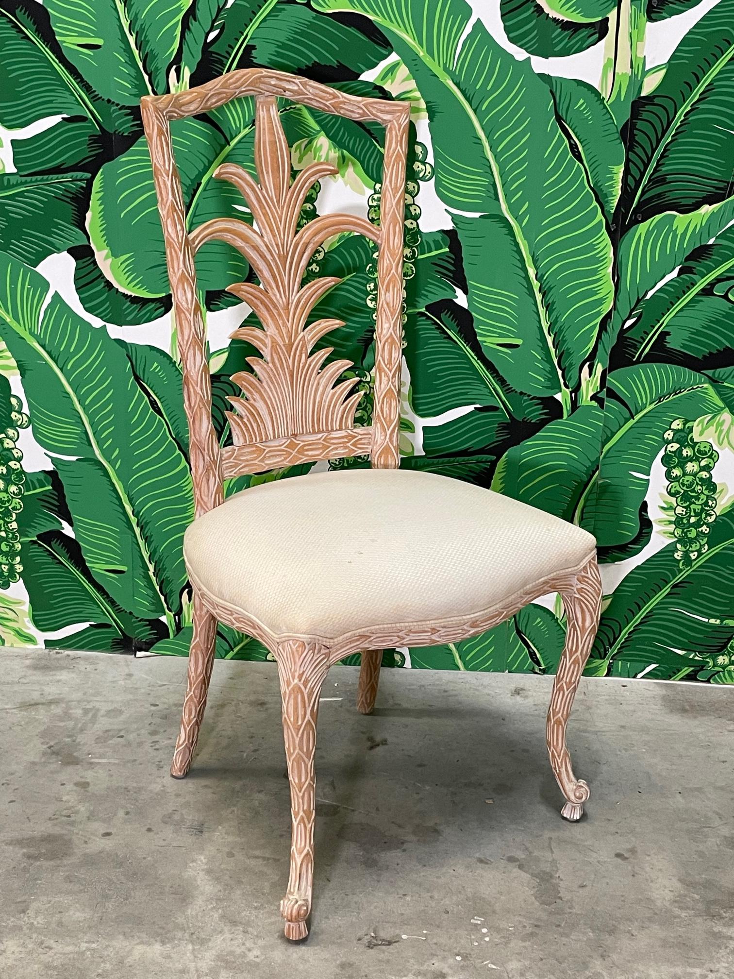 Set of six dining chairs feature faux bois style carved wood frames with a palm tree motif and splayed legs. Good condition with imperfections consistent with age, see photos for condition details. 
 White glove delivery is available to most of the