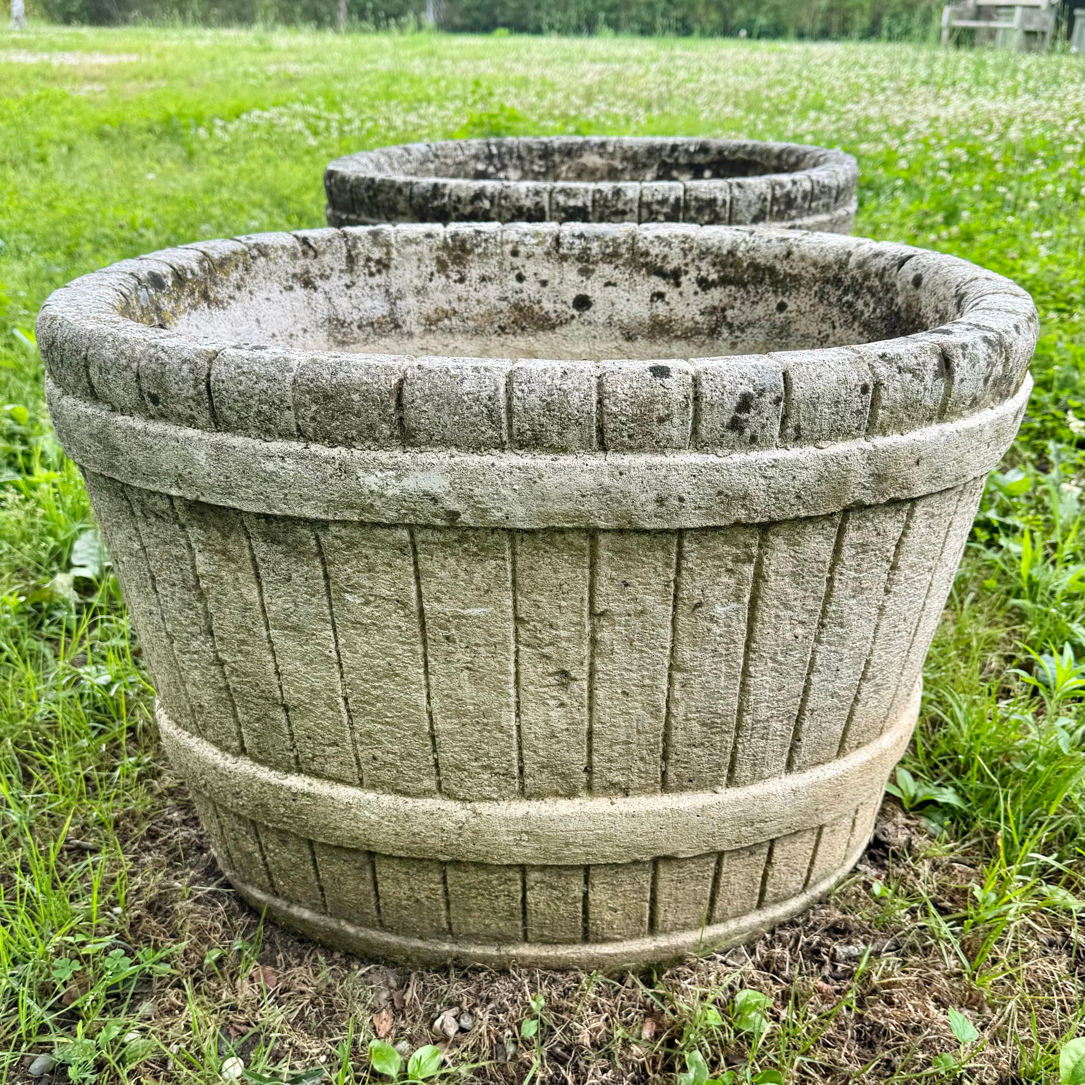 Stunning concrete faux-bois basket planters, circa 1950s.  Years of patina and weathering gives these pieces a perfectly aged and unique look. Beautiful mosses and lichen mottled throughout. Extremely substantial and well made, these planters are