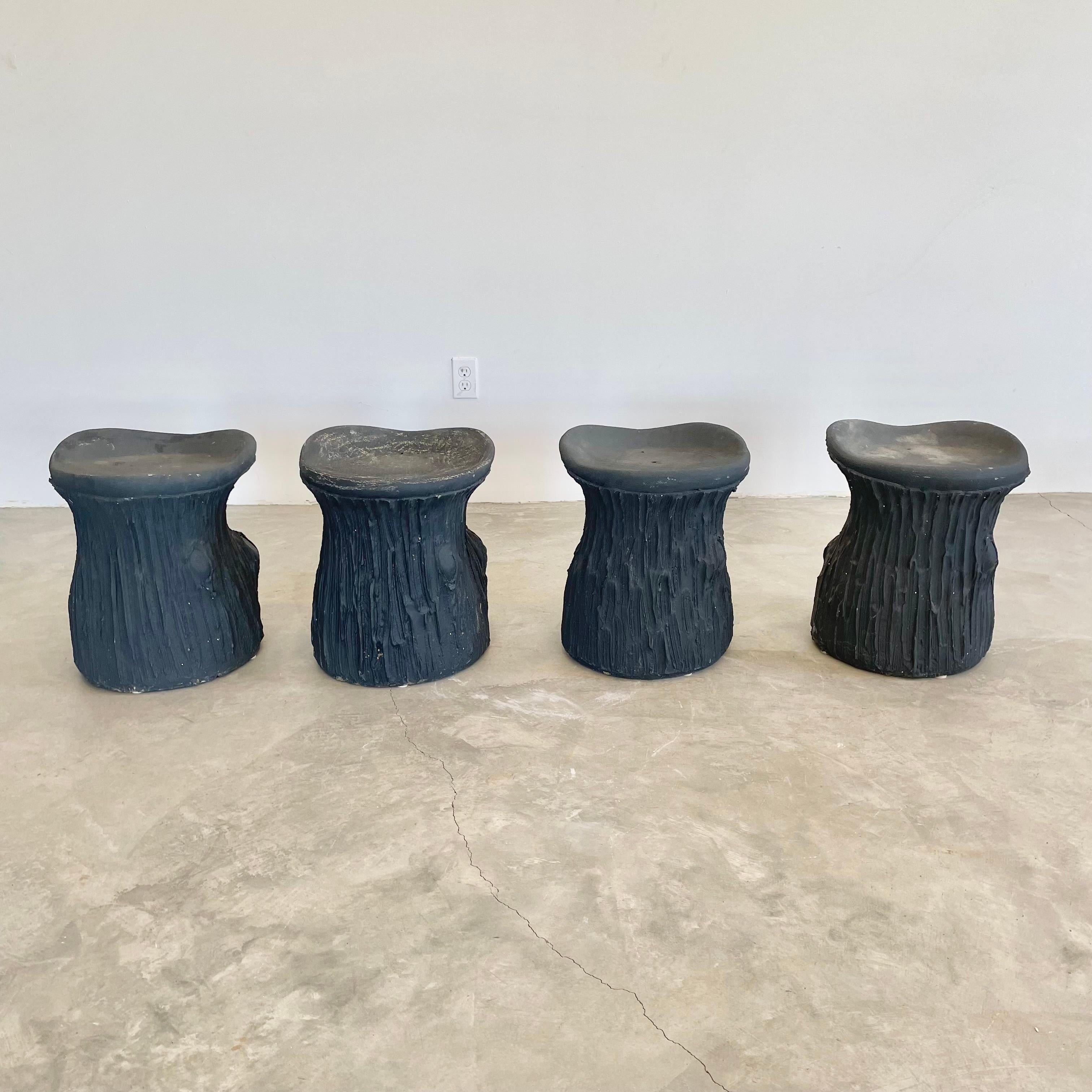 Substantial mid-century black concrete faux-bois stools, circa 1970s. Sculptural design. Great color and design details. Each stool is made of concrete which allows it to develop an incredible patina. Factory drilled drainage holes in each seat. A