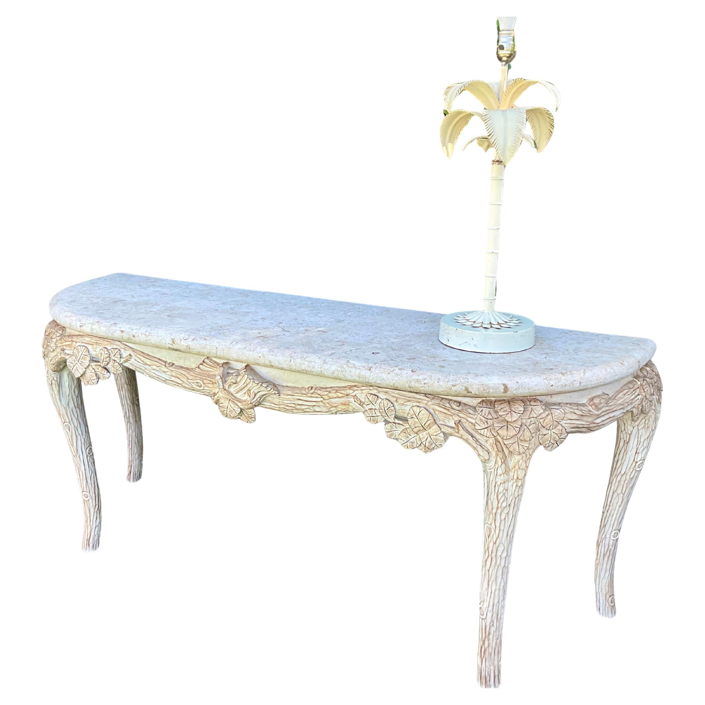 Faux Bois Console Table with Shell Stone Top

This stunning console table features a beautifully carved white-washed wood design, artfully mimicking the natural texture of faux bois. The centerpiece showcases intricate foliage details, adding a