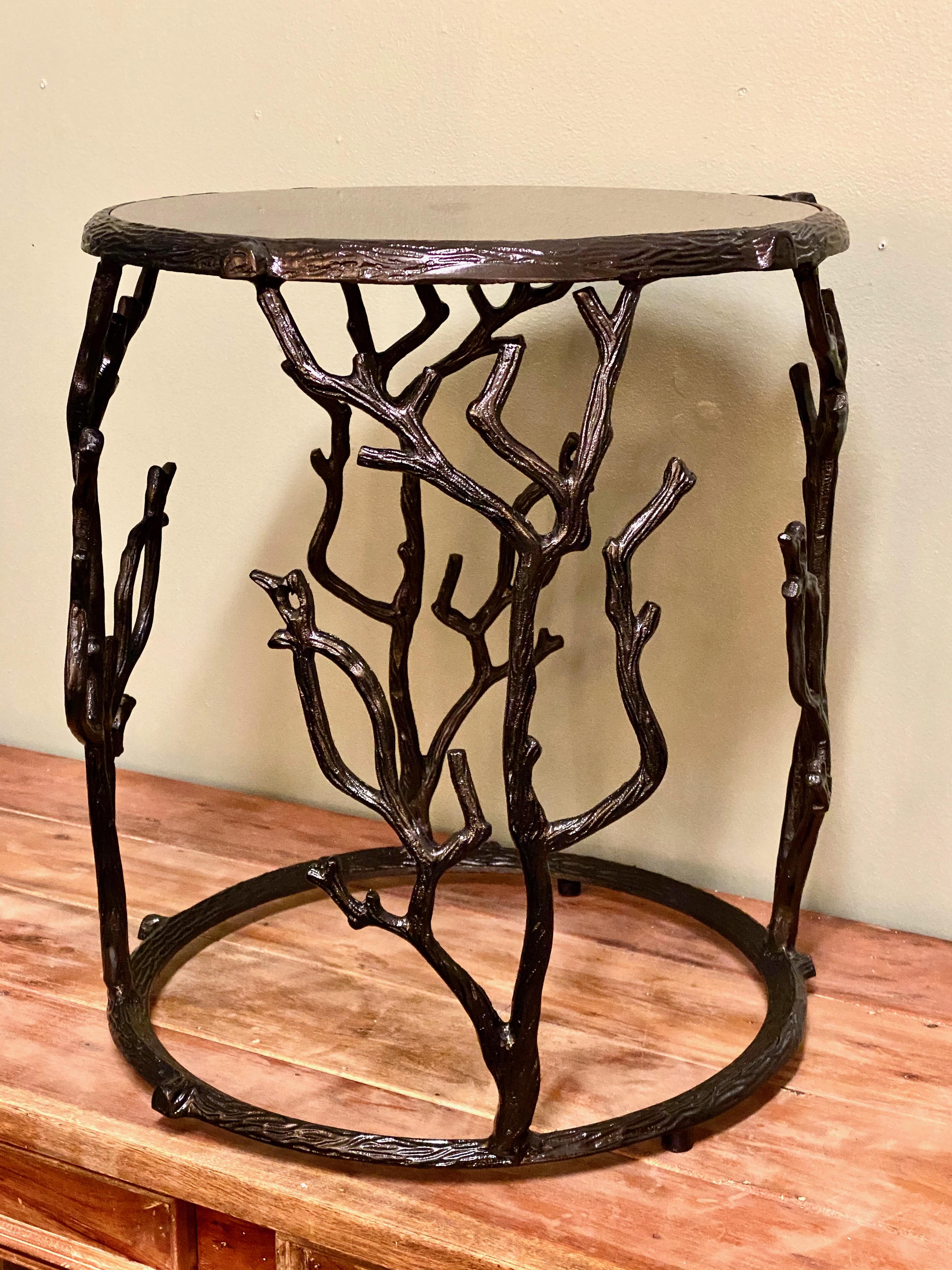 This is a charming round occasional or drinks table with a cast metal faux bois frame top with black granite.
The sculptural branch outline adds a bit of emphasis and that important touch of black.