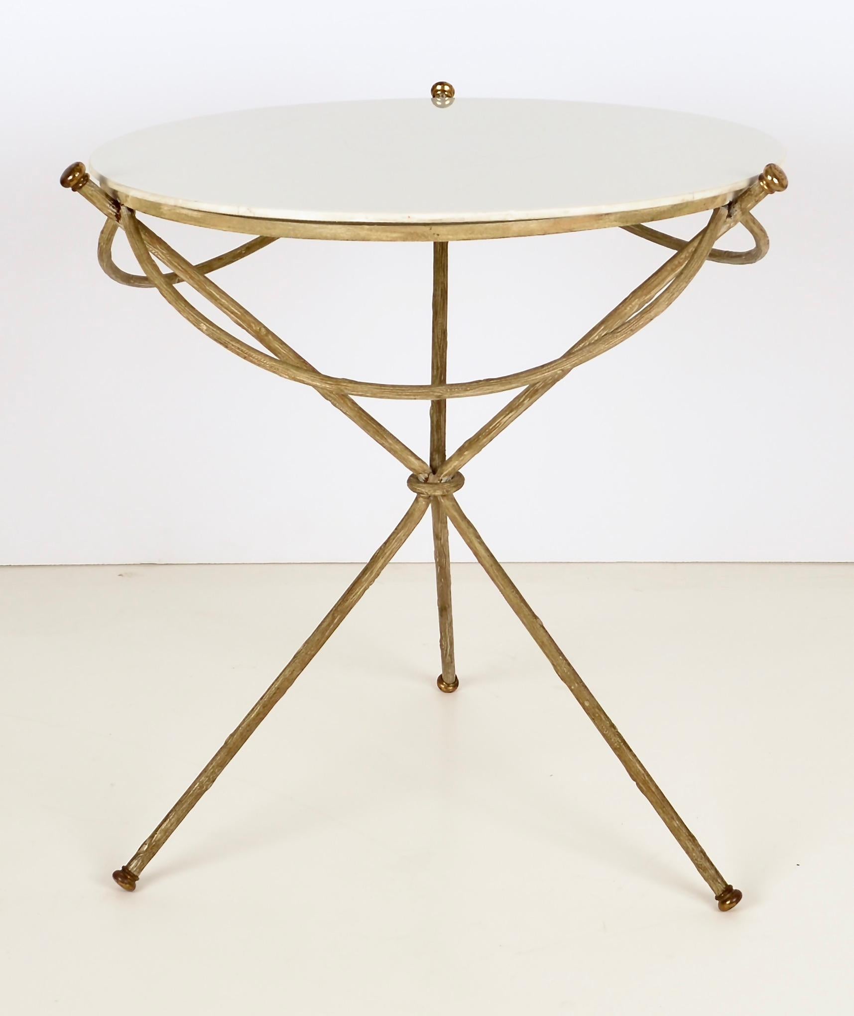 Unusual, lyrical side table with sculptural metal base featuring a subtle faux bois pattern. Brass details. French milk glass top still in fine condition, no chips or scratches.