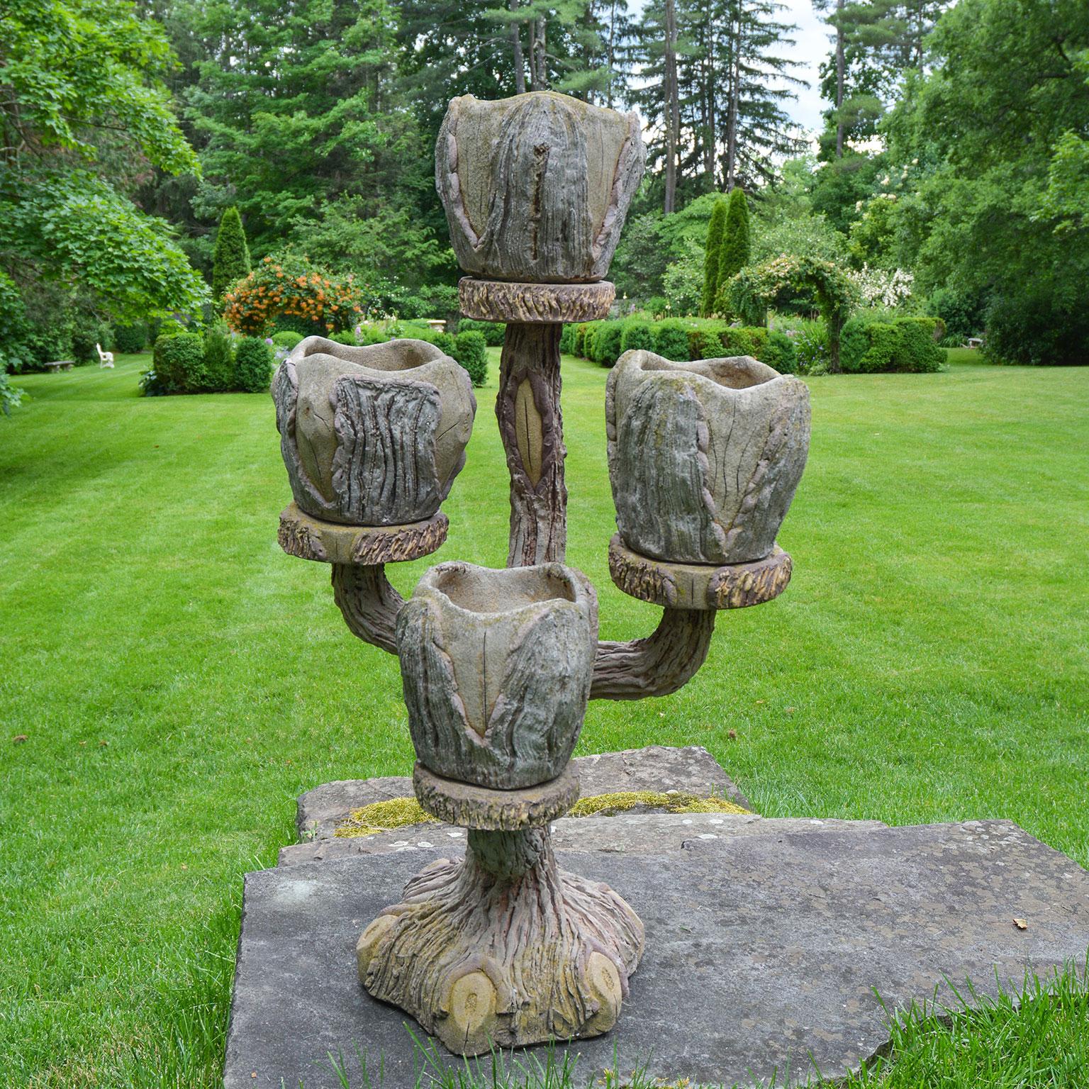 A composition stone faux-bois plant stand with four branches, each terminating in a separate cylindrical pot. French, circa 1960.