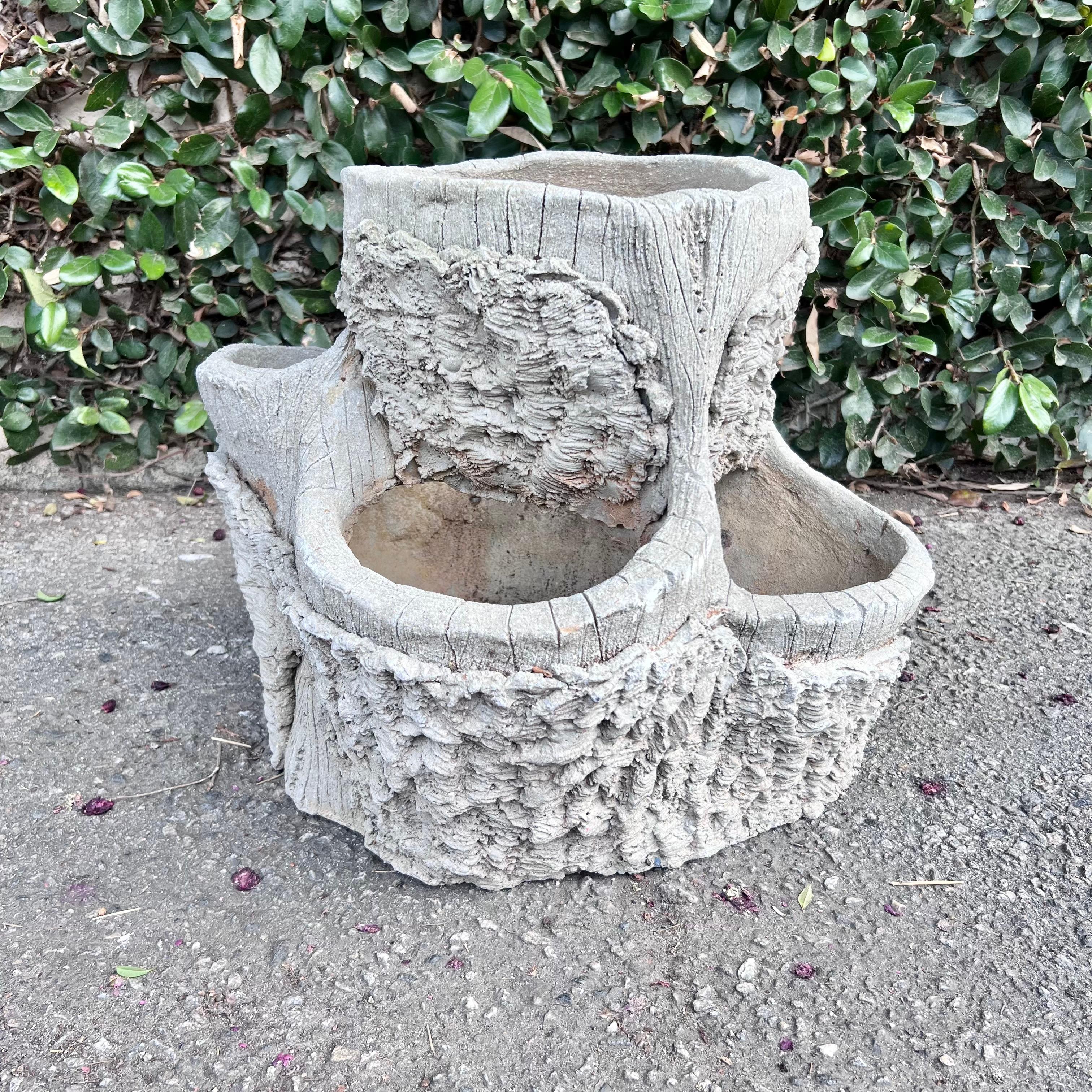 Unusual Faux Bois planter made of concrete, in the form of a tree stump. Great texture and detail. Planter has 4 mouth openings for planting. Really fun sculptural planter with a ton of presence. Good vintage condition.