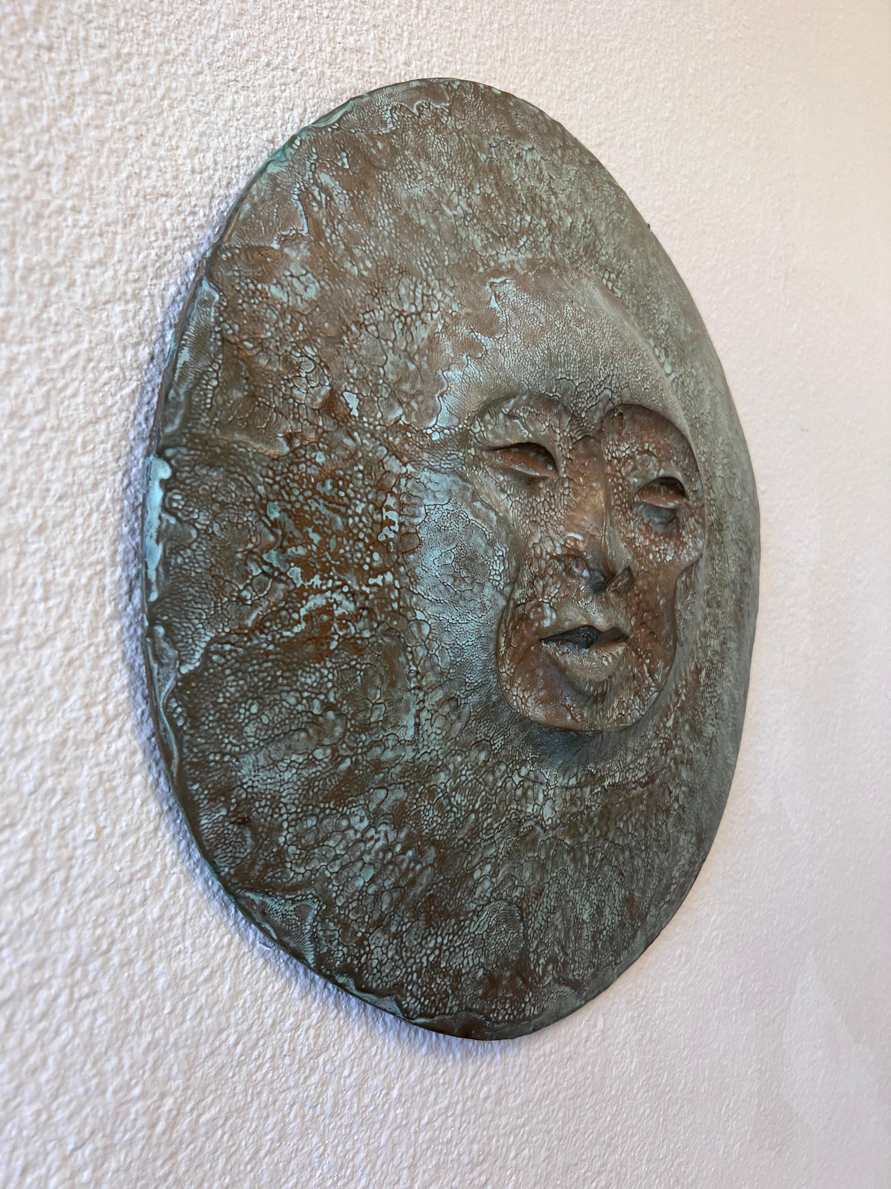 Cool 1970’s faux bronze sun face wall sculpture. 
We believe it’s cast resin with a patinated bronze finish. In good original vintage condition.