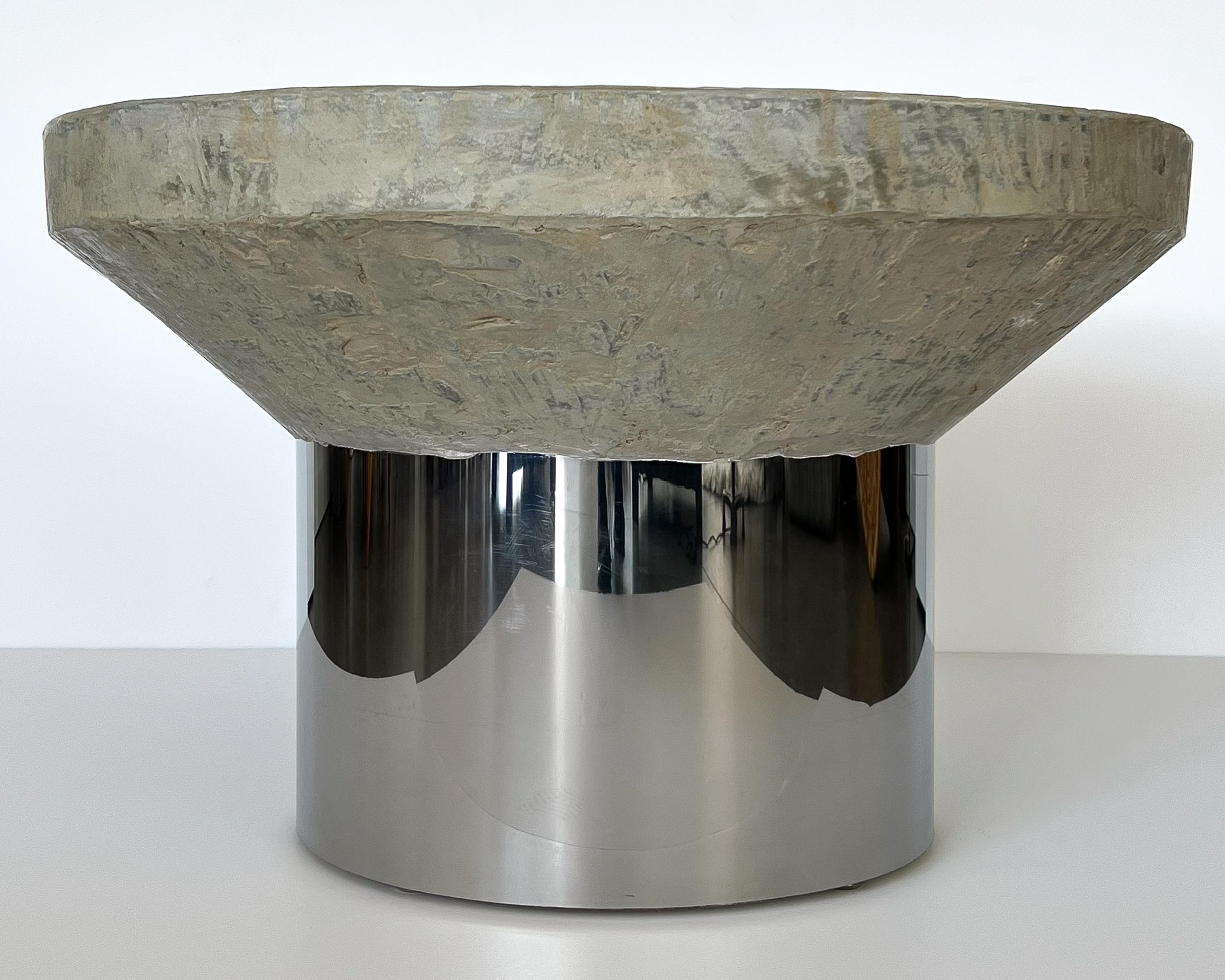 Unique faux cement / concrete and chrome pedestal coffee or end table, circa 1970s. Unknown designer. Highly textured resin faux cement top in pale gray and tan with a monolithic wedge design. The top measures 27.5