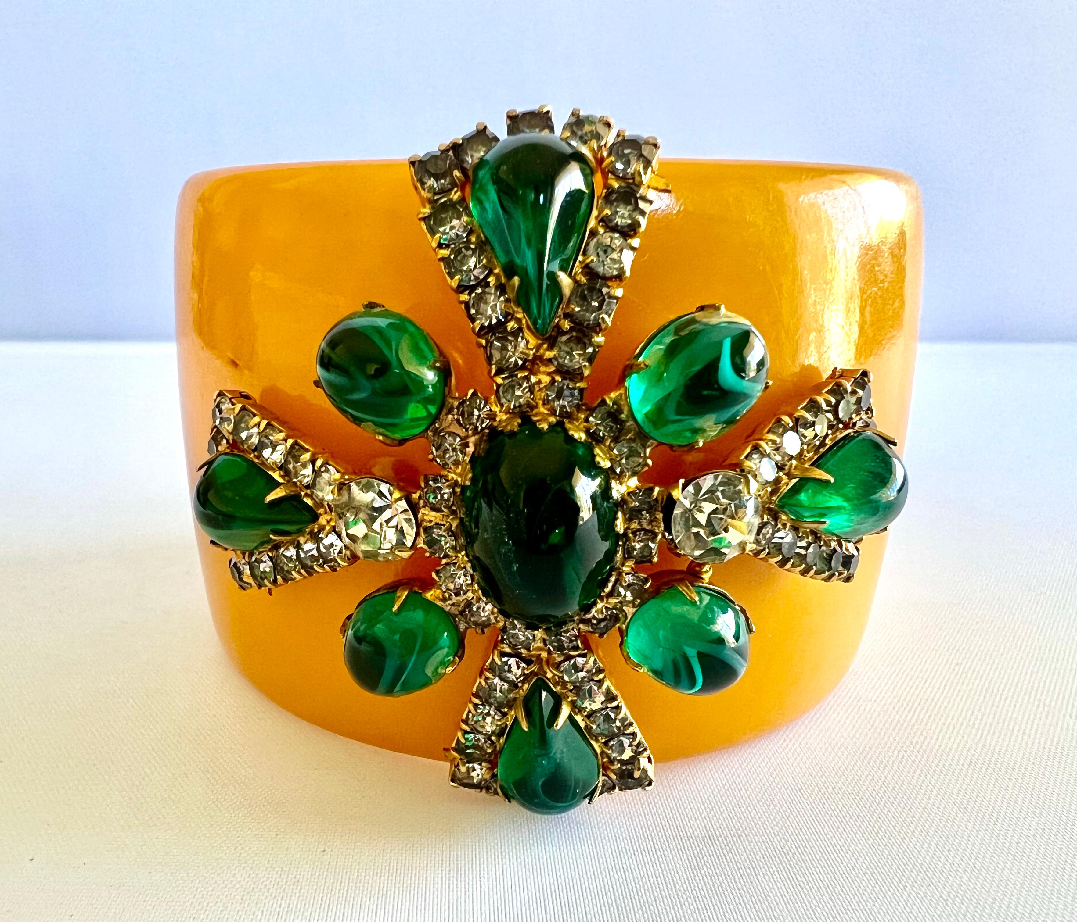 Faux cabochon emerald and diamante butterscotch bakelite bangle bracelet accented by a sizeable Maltese cross. 