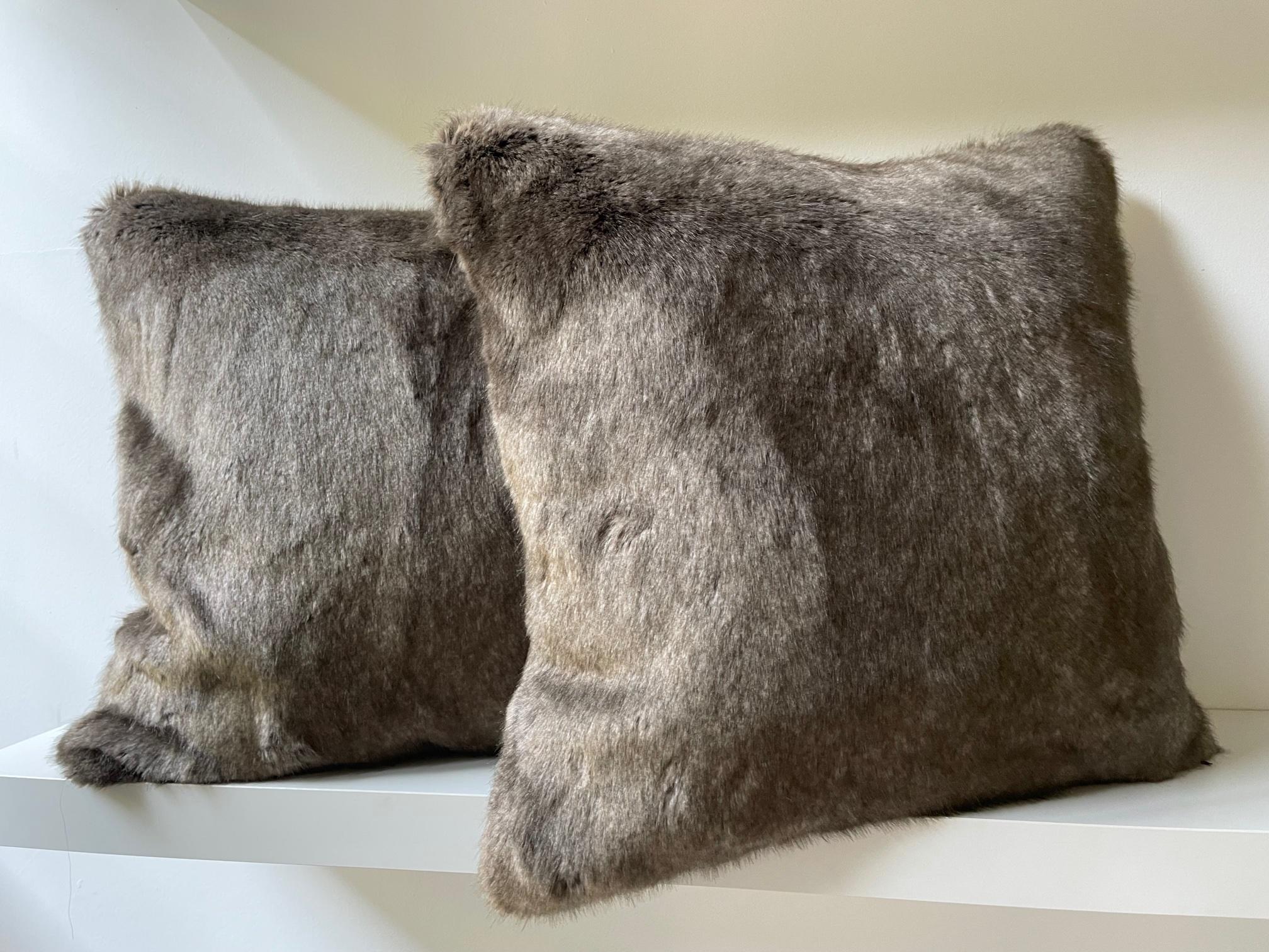 1 pair faux fur cushions col. brown melange with silk brown at the back, very high end faux fur in combination with silk, finish with silk piping, cushion cover with concealed zipper and cotton lining, feather inner.