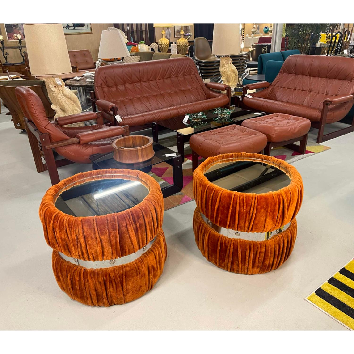 This vintage 1970s end / side table set pulls out all the stops. The tables are gratuitously covered in thick furry fabric with undulating folds of fabric giving a look of decadence. The generous upholstery is gathered by a studded chrome band at