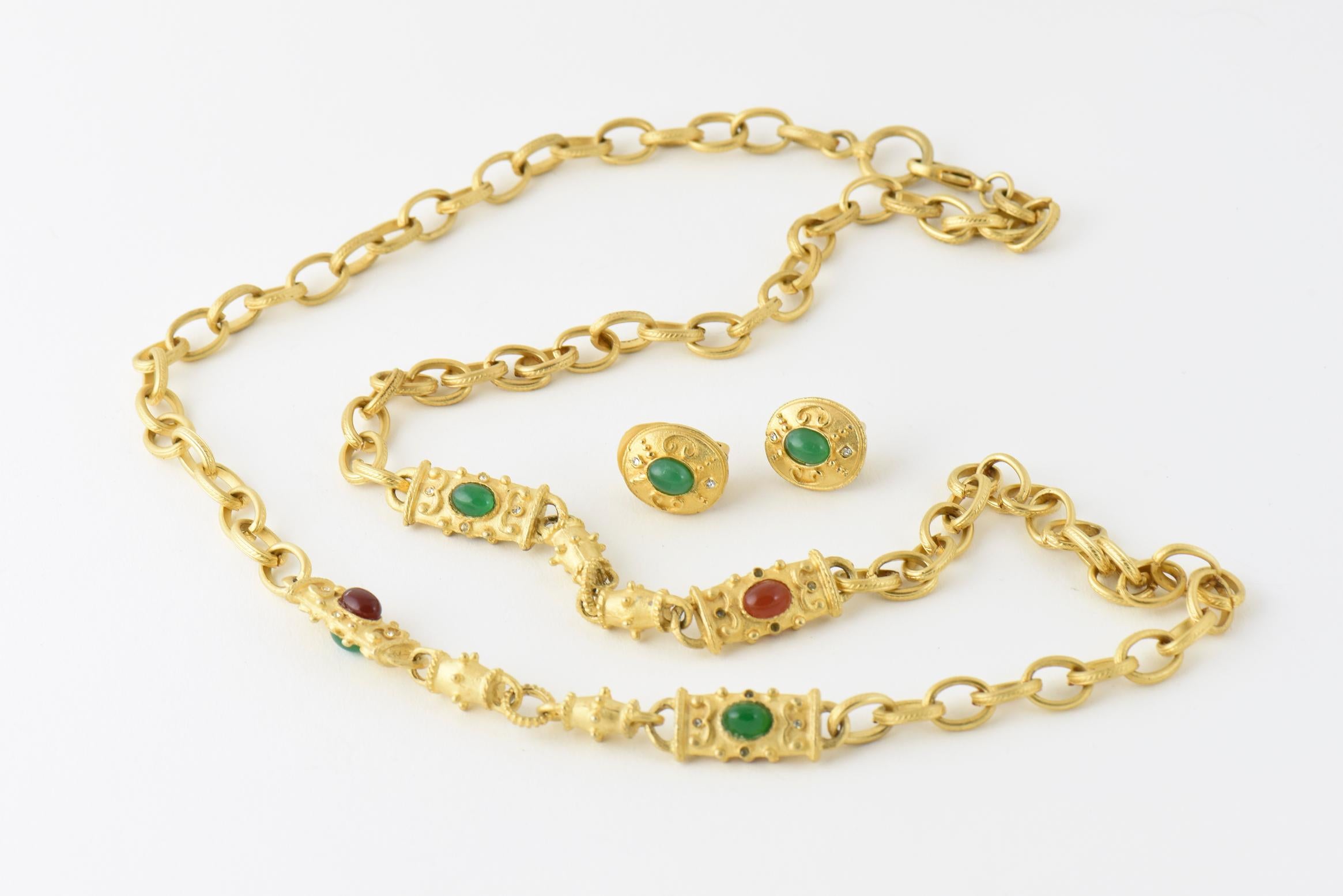 Goldtone chain link necklace with line design on links, accented with oval faux-carnelian and faux-emerald cabochon centers. Matching oval faux-emerald earrings with clip backs. Earrings: 0.75