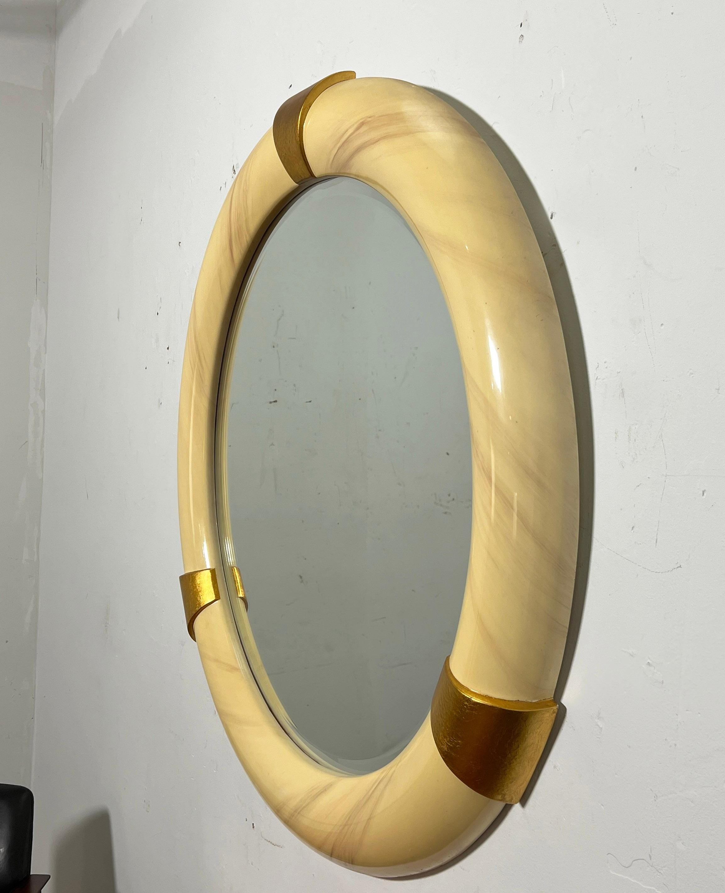 Rondelle wall mirror lacquered in a faux goatskin pattern, with gold leaf accents.