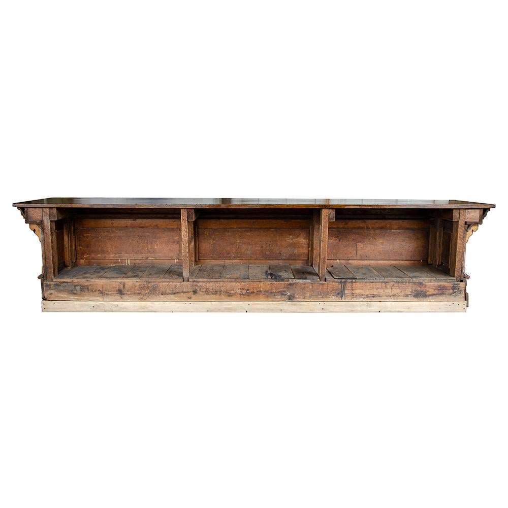 This exceptional 12' country store counter is a solid beauty. The front panels are painted with a delicate faux graining and the block top makes for an elegant statement for any space. The open back allows for plenty of storage possibilities, late