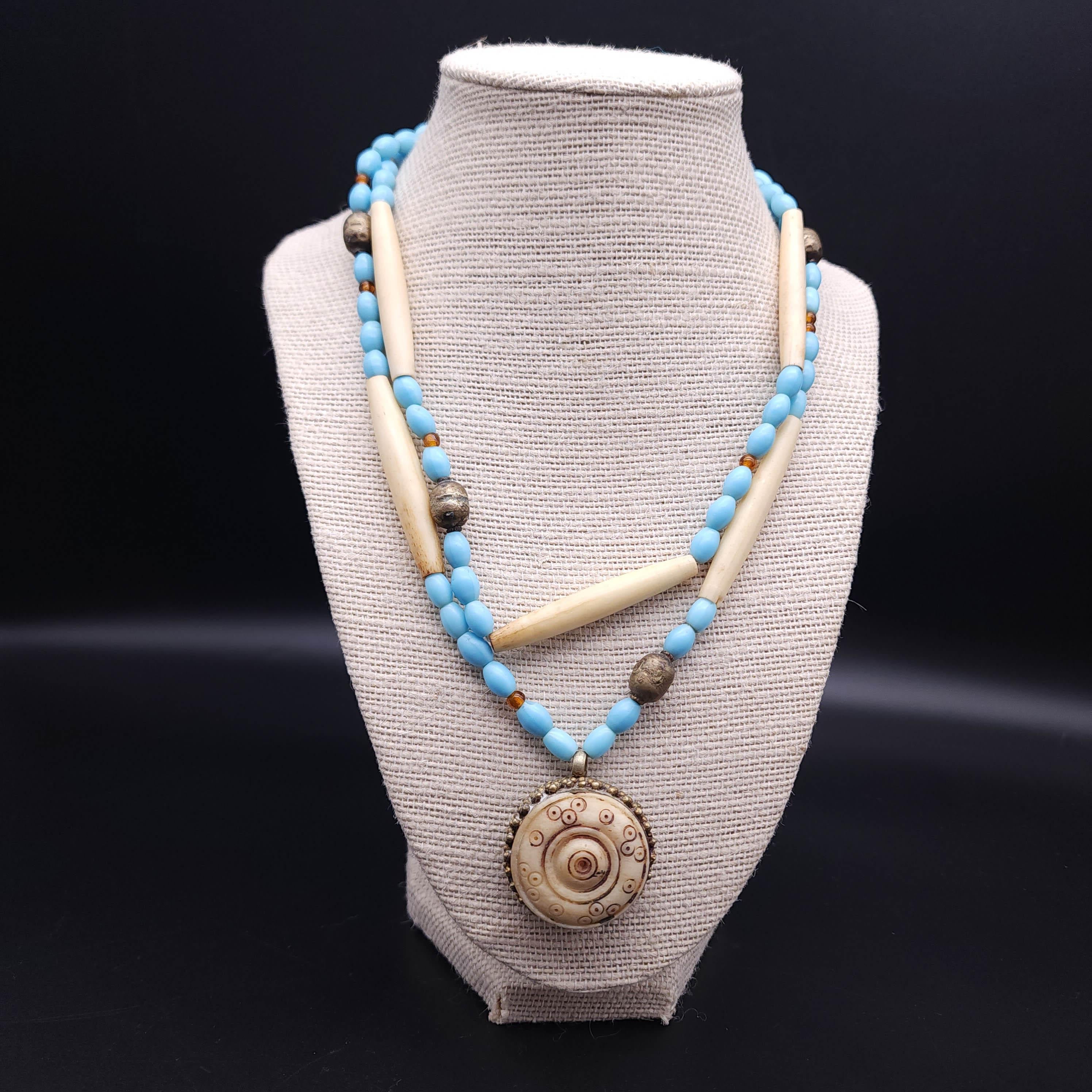 Elevate your accessory collection with this exquisite double strand bead necklace, a harmonious blend of elegance and vintage charm. The necklace features a duo of strands adorned with faux turquoise beads that evoke the serene beauty of the ocean,