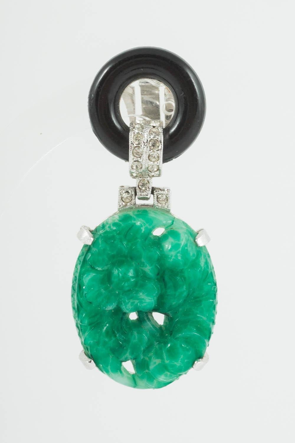 Beautiful faux jade and onyx earrings by Kenneth Lane.  Made from moulded glass drop, that imitates carved jade, reminiscent of pieces produced by Cartier in the 1920s, and a glass circle of faux onyx on top. Then clear paste highlight the earrings.