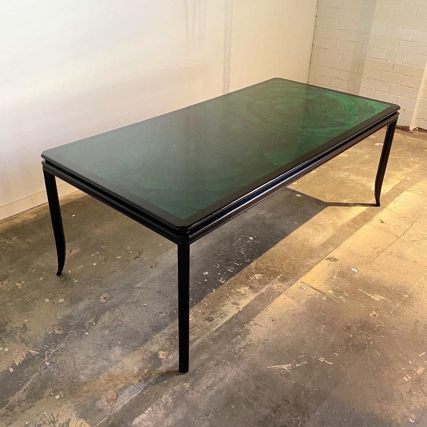 A vintage glam faux malachite dining table. This is a unique example in very good vintage condition. Although the table shows some signs of age and use the striking color and hand painted design show wonderfully.