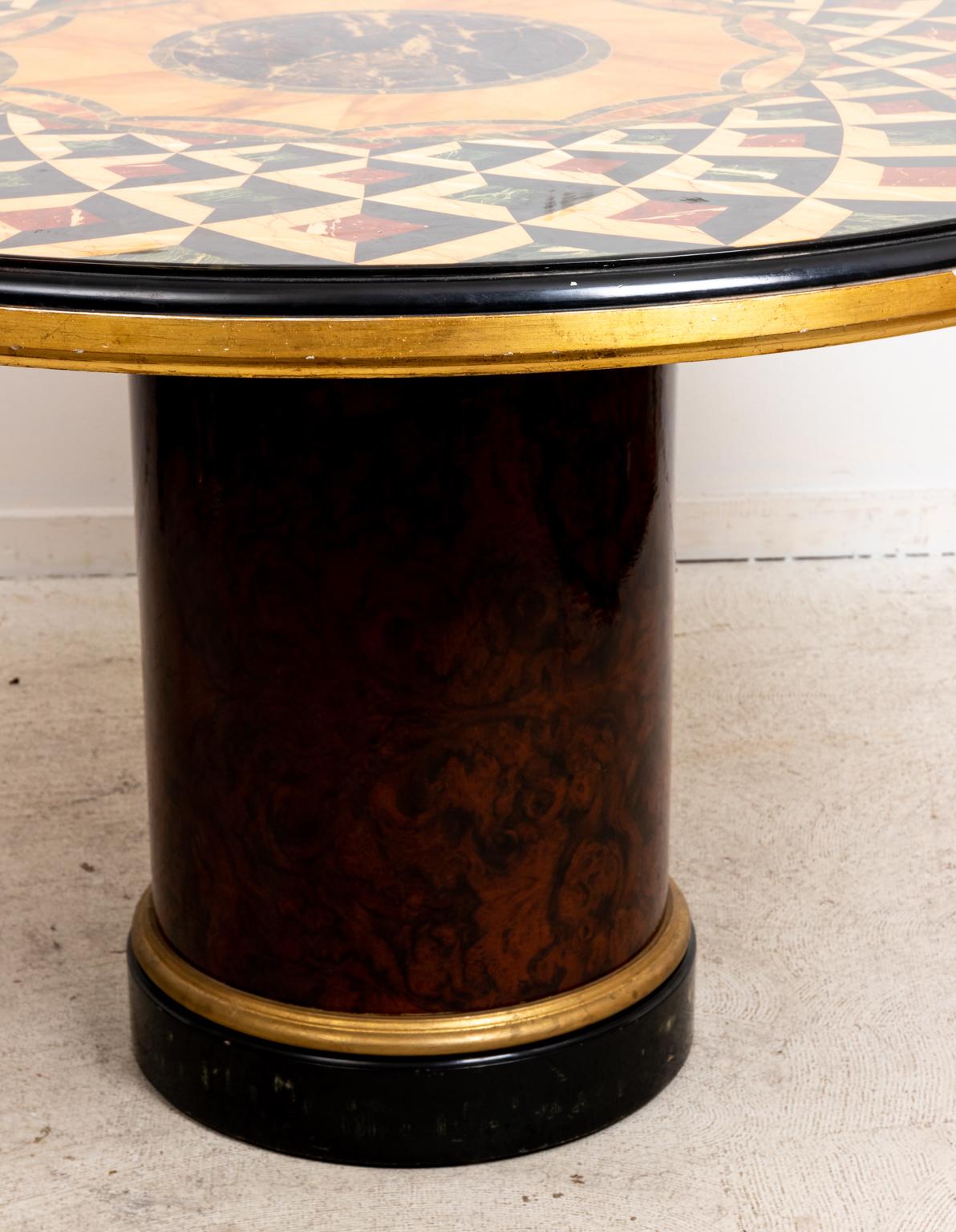 Faux marble decorated center table on a drum shaped pedestal base. The tabletop is heavily detailed in faux marble with a repeating geometric pattern and center patera medallion. Please note of wear consistent with age including minor finish loss.