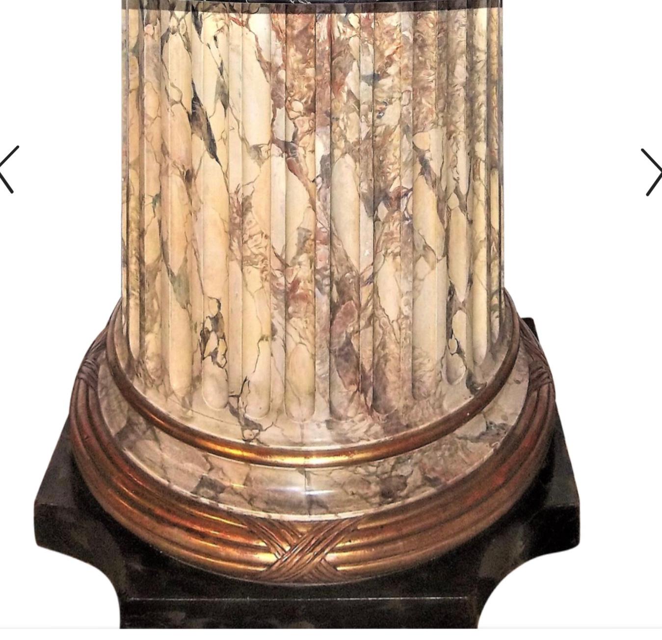 Large fluted columnar base with faux marble decoration and gilded banding. Mounted with gold and creamed veined marble (often called Portoro) probably as a center table but large enough for small dining. 

Marble-top in fine shape no nicks or chips.