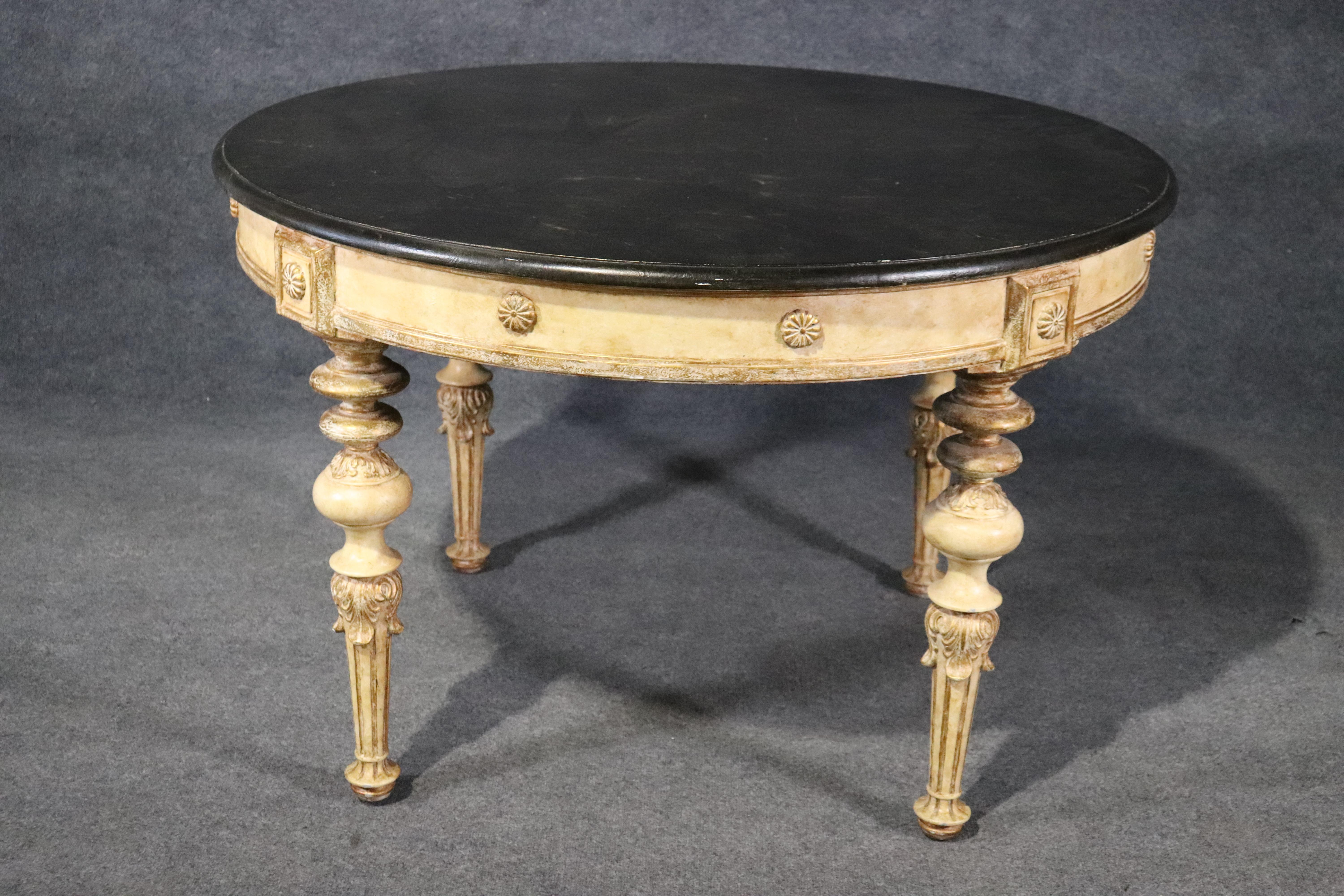 This is a gorgeous paint decorated table with a dark green faux marble top and gorgeous creme painted base with subtle hints of gold. The table is in very good condition and has no significant signs of wear or use. The table measures 48 x 48 x 31.5