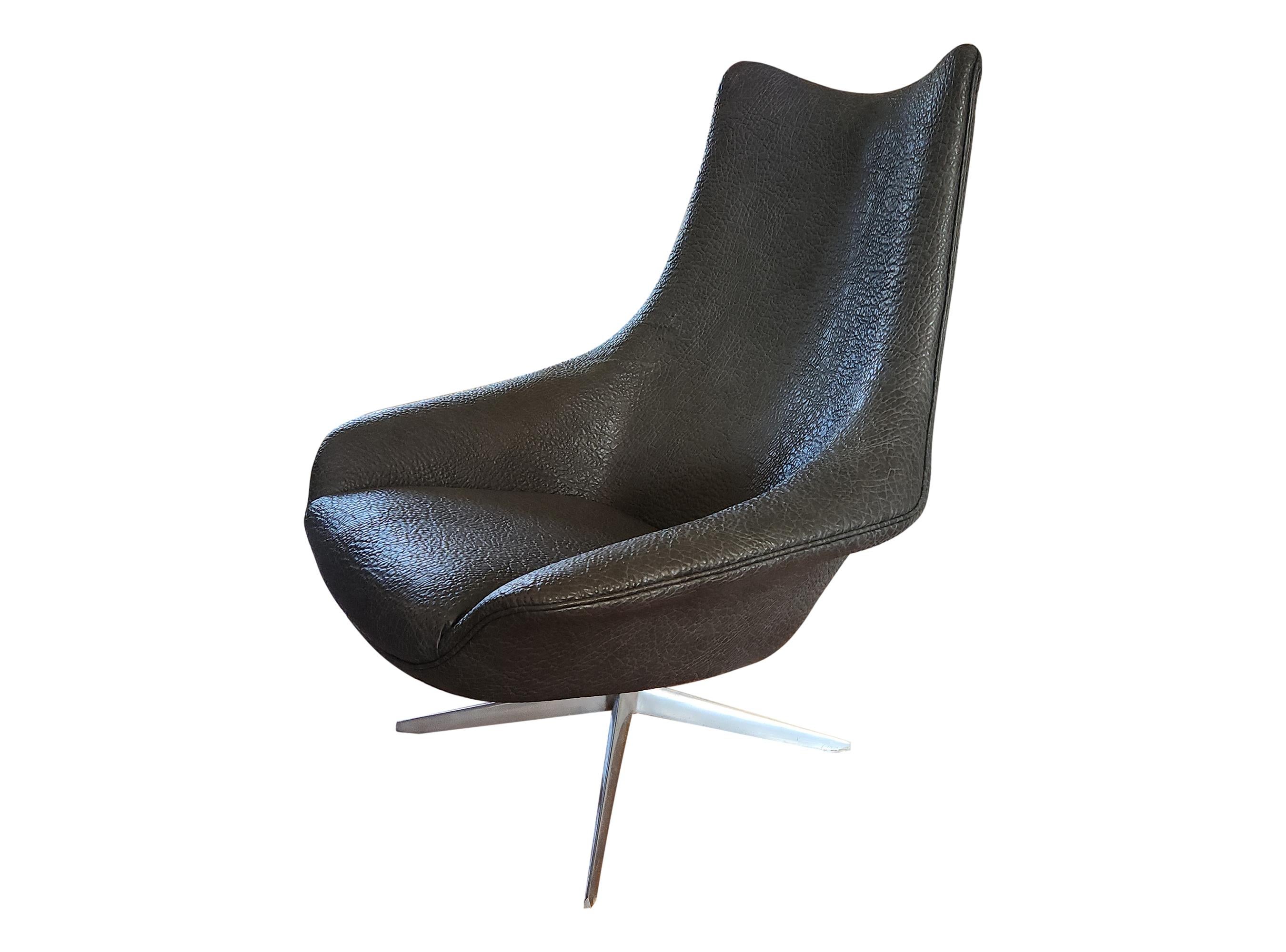 This swivel living room chair has been newly upholstered in faux ostrich leather. Its base is polished aluminum, and the frame is molded fiberglass, making it very light.  This chair also has two arm rests embedded in the frame.



