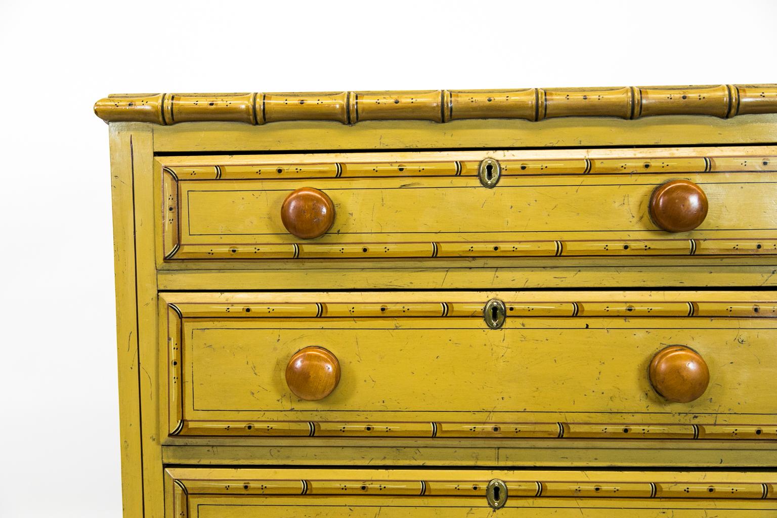 Faux painted bamboo chest, has its original fruitwood knobs and the drawers have beveled edges. The keyhole escutcheon is later.
 
