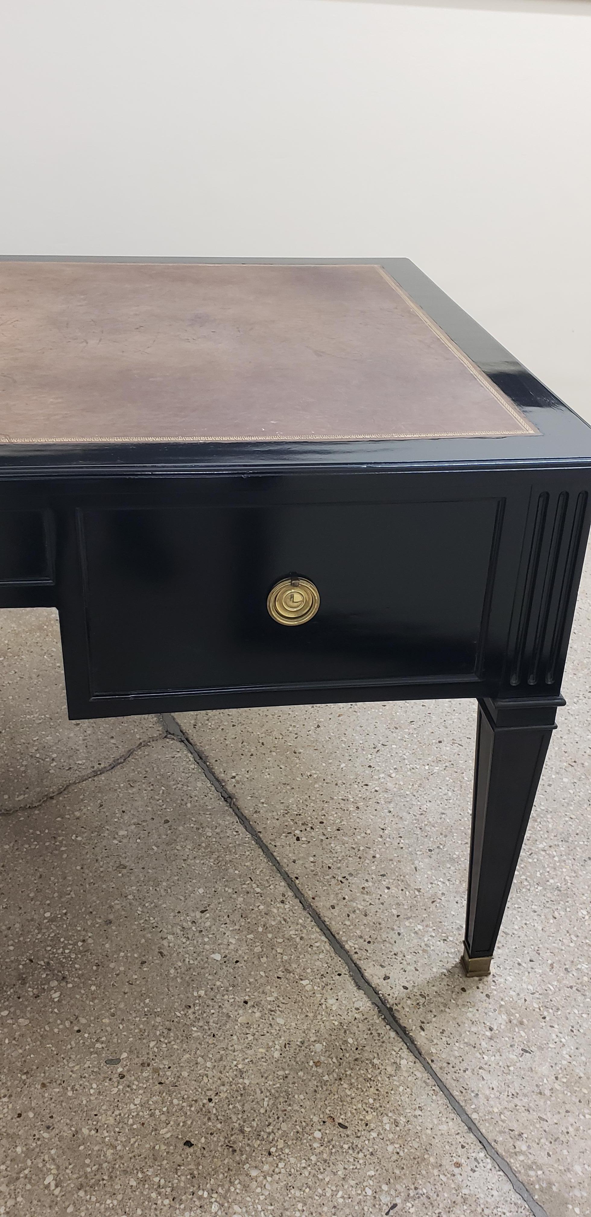 Faux-partner leather top bureau plat/ writing desk in the Louis XVI manner.