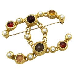 FAUX PEARL AND RESIN CHANEL CC BROOCH, gold plated, 2018 Collection