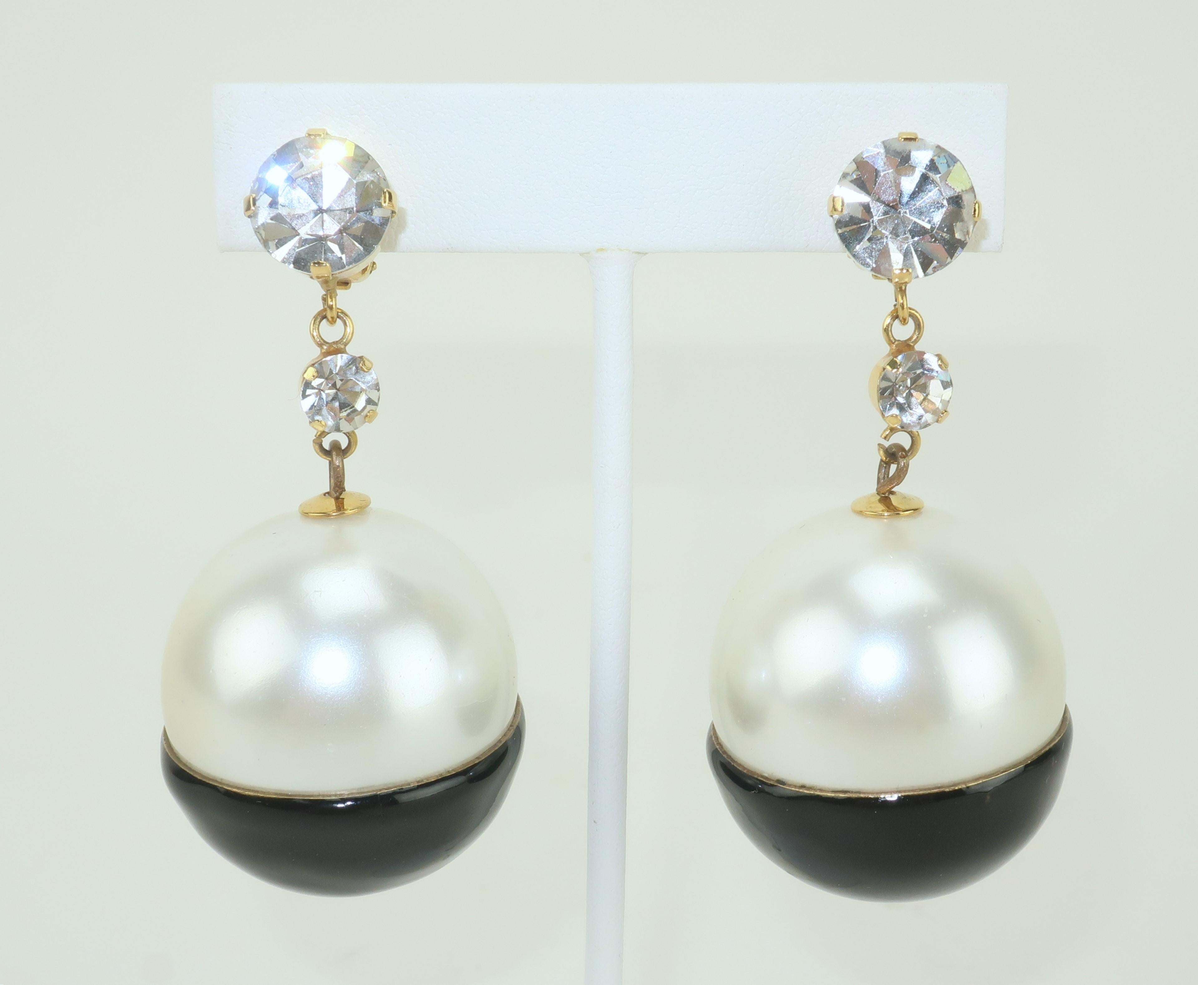 What a great combination of a classic look with a youthful style!  These fun C.1980 clip on orb shaped earrings mix a faux pearl with a black enamel and then top it all off with sparkling rhinestones set in gold tone metal.  They are not hallmarked