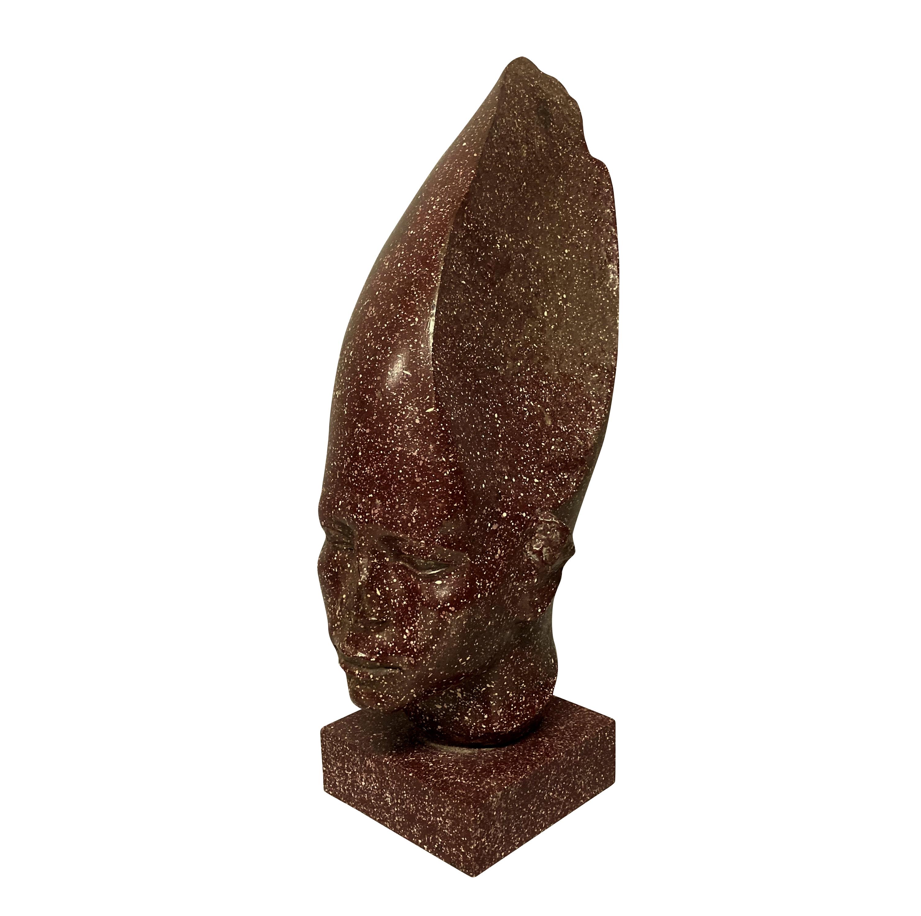 An English faux porphyry Egyptian head on plinth by Redmile, after the antique.