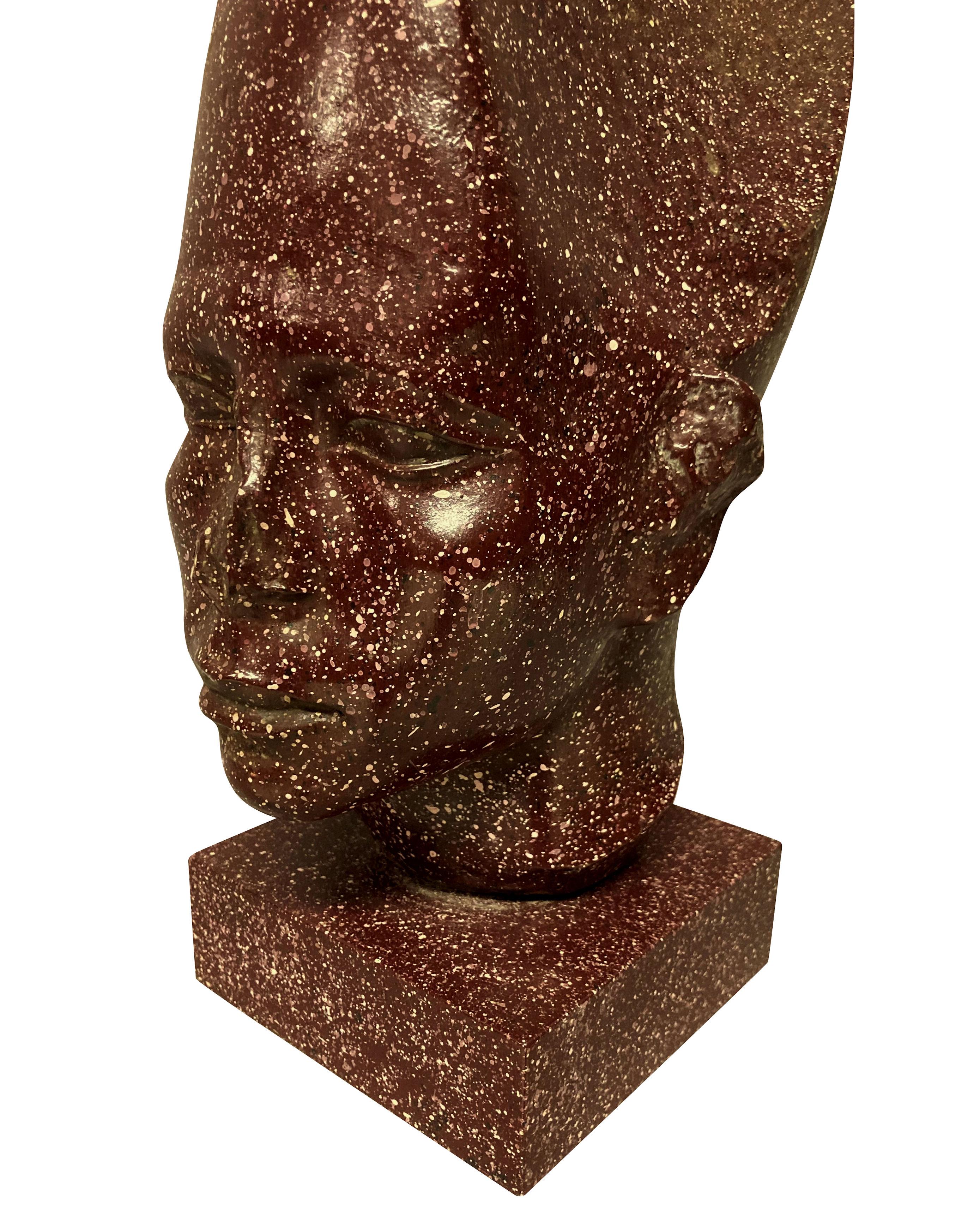 An English faux porphyry Egyptian head on plinth by Redmile, after the antique.