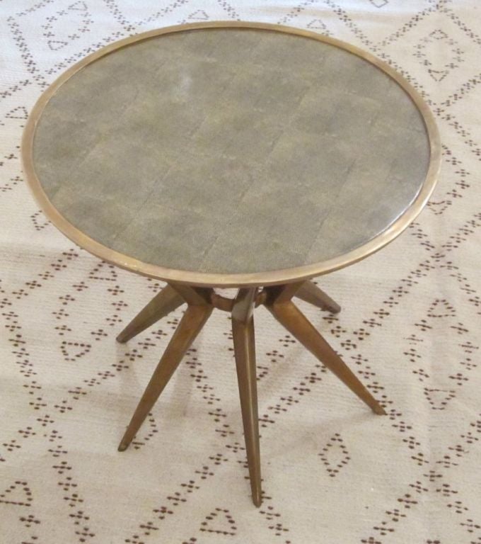 Faux shagreen green print transferred onto a round porcelain top with brass base. Brass trims the top.
Great small side or cocktail table.
 