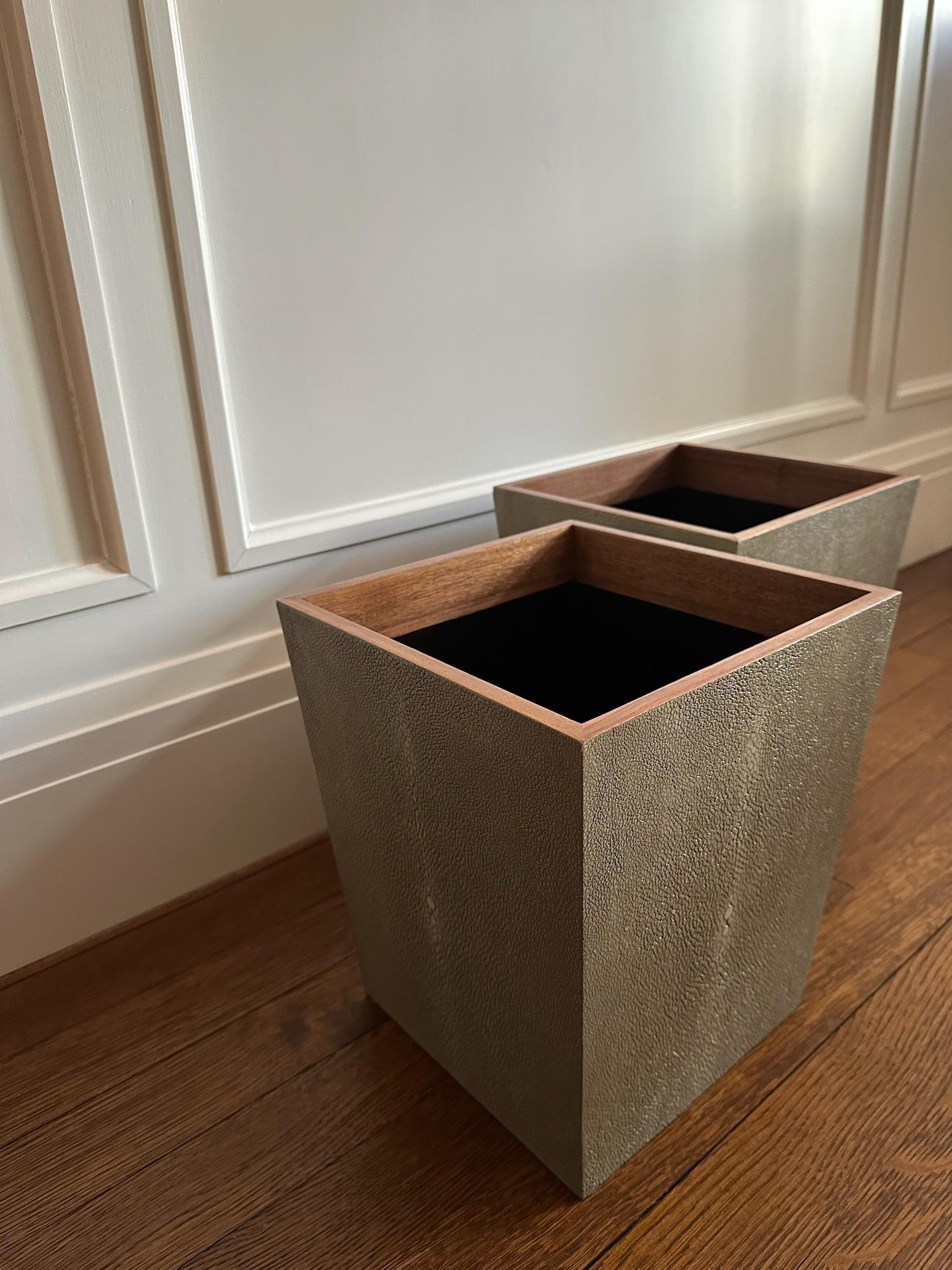 The outer sides of the wastebasket are beautifully crafted to mimic the natural eye pattern of shagreen, topped with a veneer trim. 2 wastebaskets available - priced separately but can be bought together.