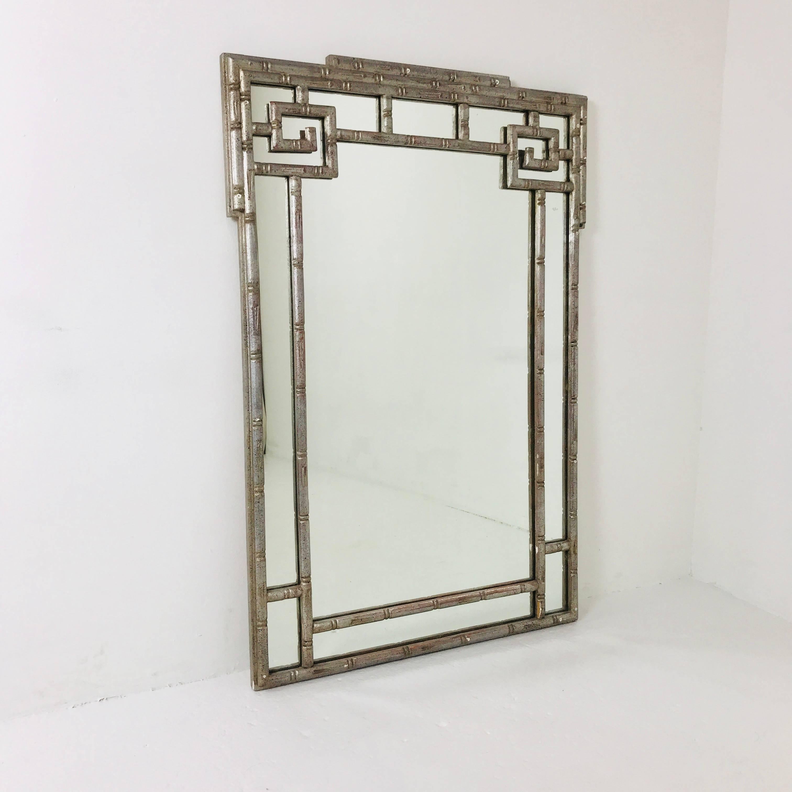 Faux silver leaf Greek key mirror. Mirror is in good vintage condition with wear due to age and use.

Dimensions: 29