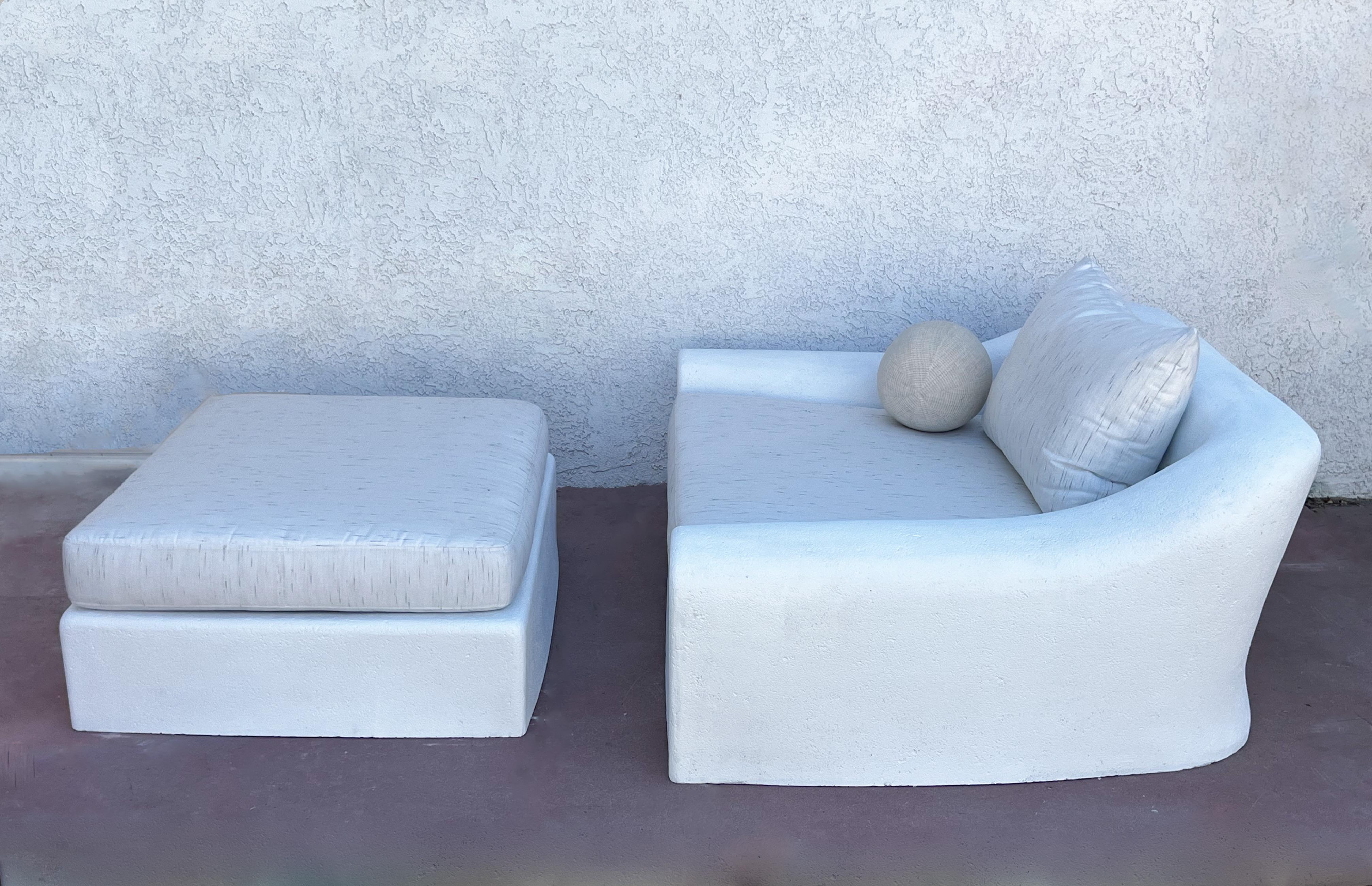 Large white sculpted faux stone ‘Jennifer’ lounge chair and ottoman by Michael Taylor. 
Chair is big enough for two people. 
Newly restored with new Sunbrella  Frequency Parchment fabric. 
Constructed of fiberglass and concrete.