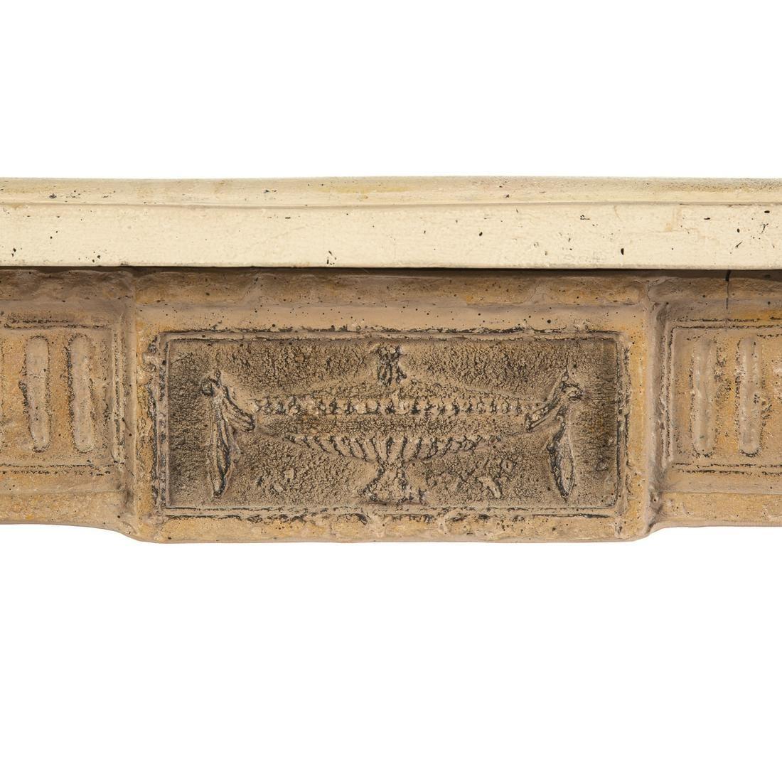 Faux stone topped rustic French console with carved tapered legs and medallions and notched corners to the top.