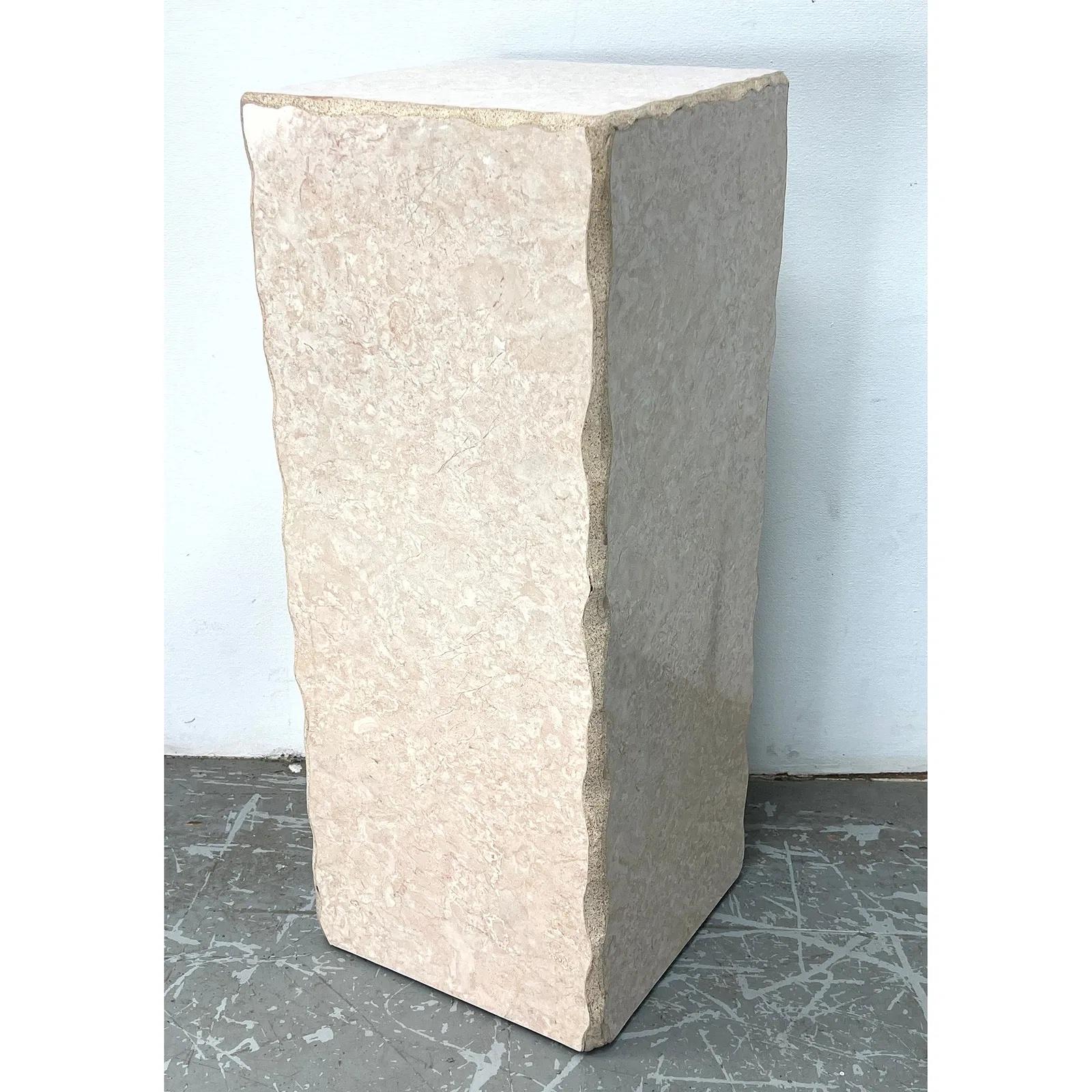 A striking hexagonal travertine pedestal from Italy. This piece features a geometric form with clean lines and showcases the natural beauty of travertine stone, including its characteristic veining and subtle tonal variations.