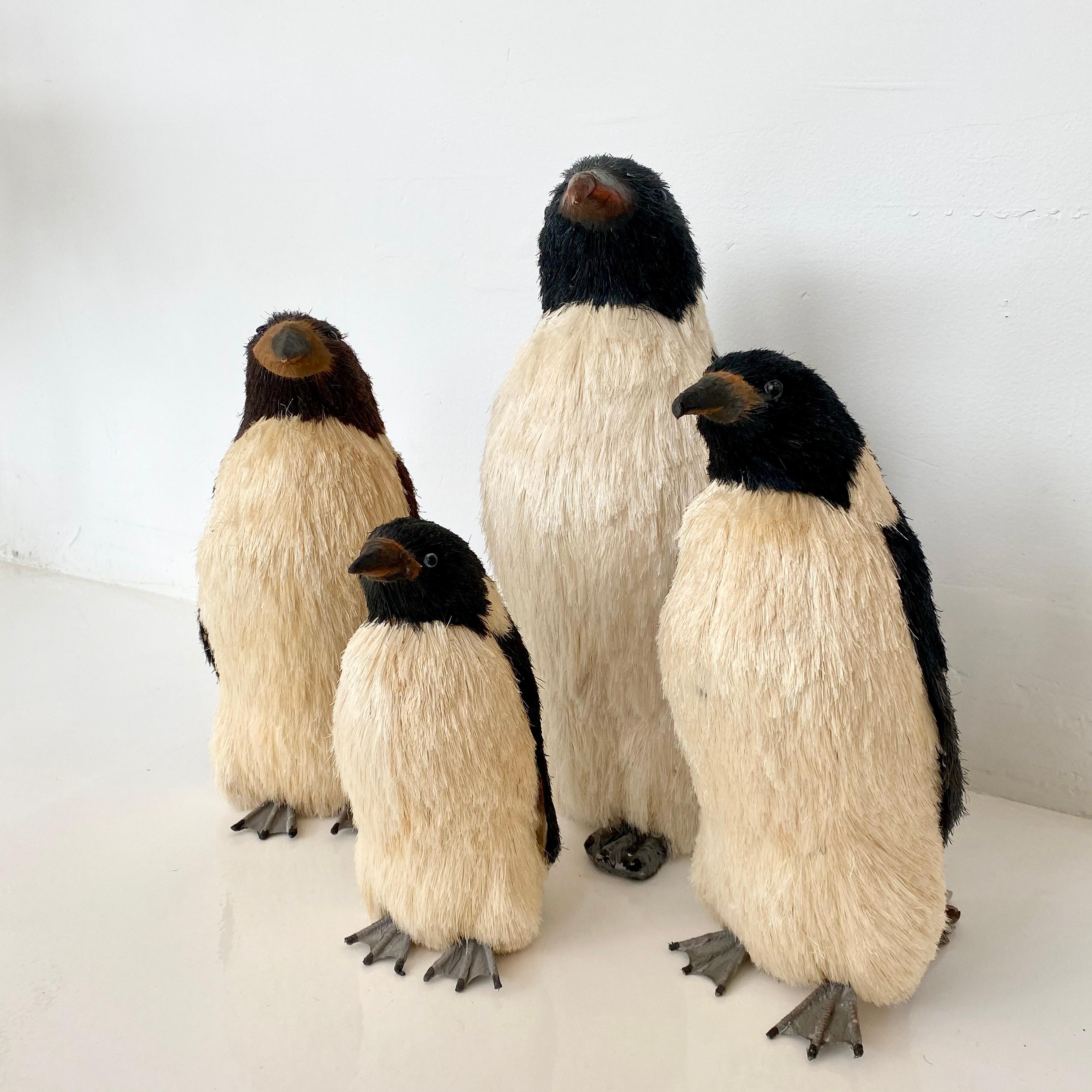 Vintage set of faux taxidermy penguins. Bodies are made of foam and papier mâché. Hair is made out of a synthetic fiber that resembles bristles. Hand painted. Set of four includes : one small, two medium, and one large. Priced as a set of 4. Good