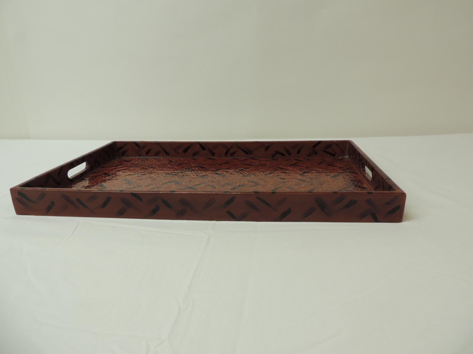 Faux tortoise finish lacquered rattan serving tray with open handles.
Is big enough to hold books or magazines.
Size: 12 x 20 x 1.5 H.