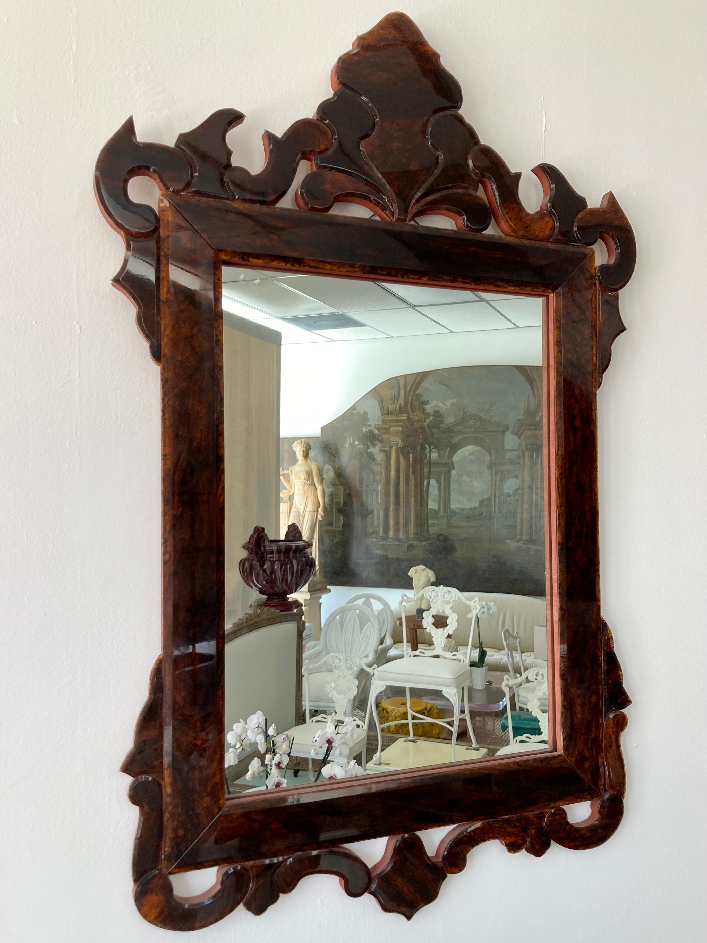 Faux tortoise glass mirror in a traditional shape and design. Each piece of the the frame is a special faux tortoise glass that is cut beveled to creat the design of the frame . Add some serious glam to your home with this fine artistry.