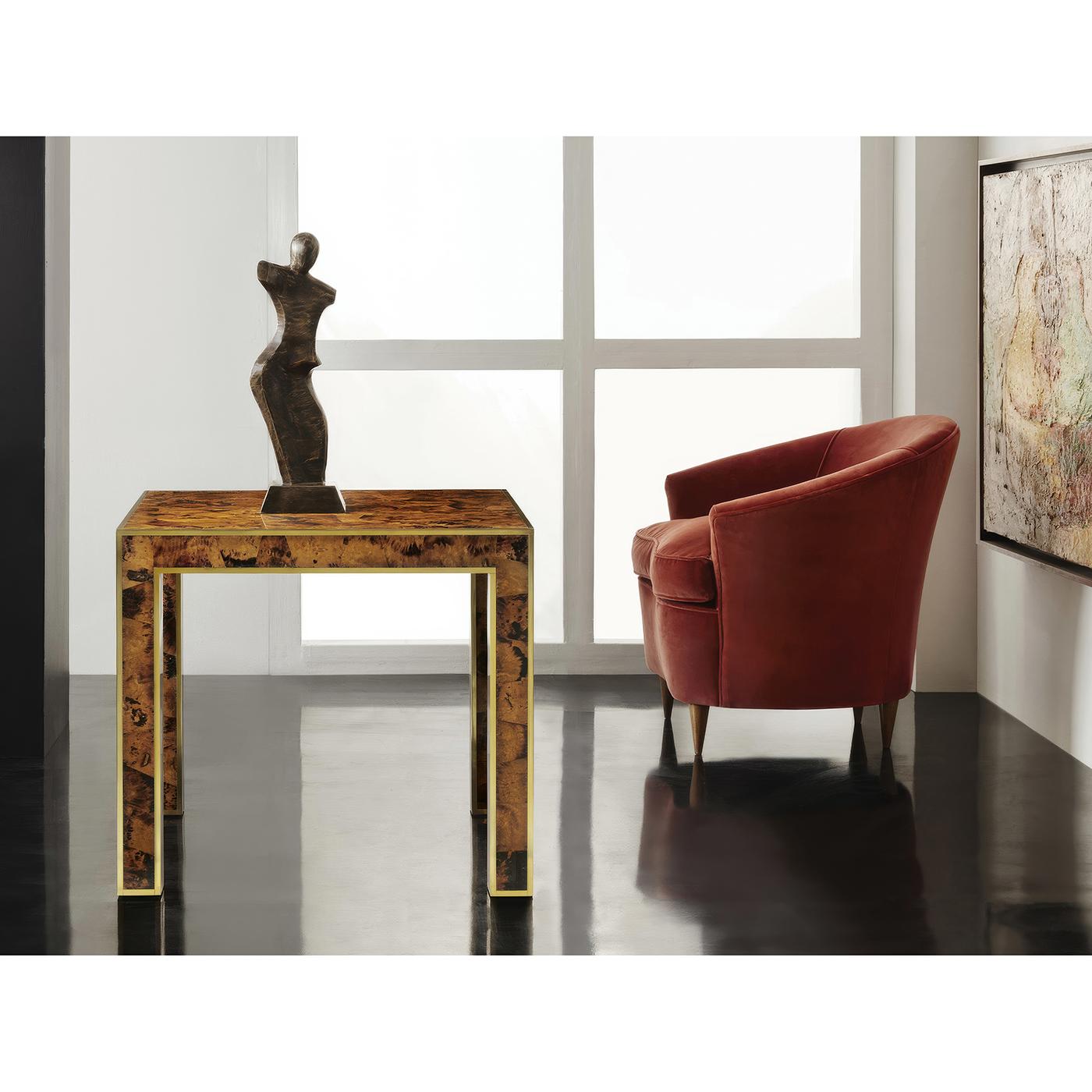 A mid-century modern style end table with a hand-painted faux tortoise pen shell decoration. Framed with brass trim to all outside edges raised on squared legs.

Dimensions: 27