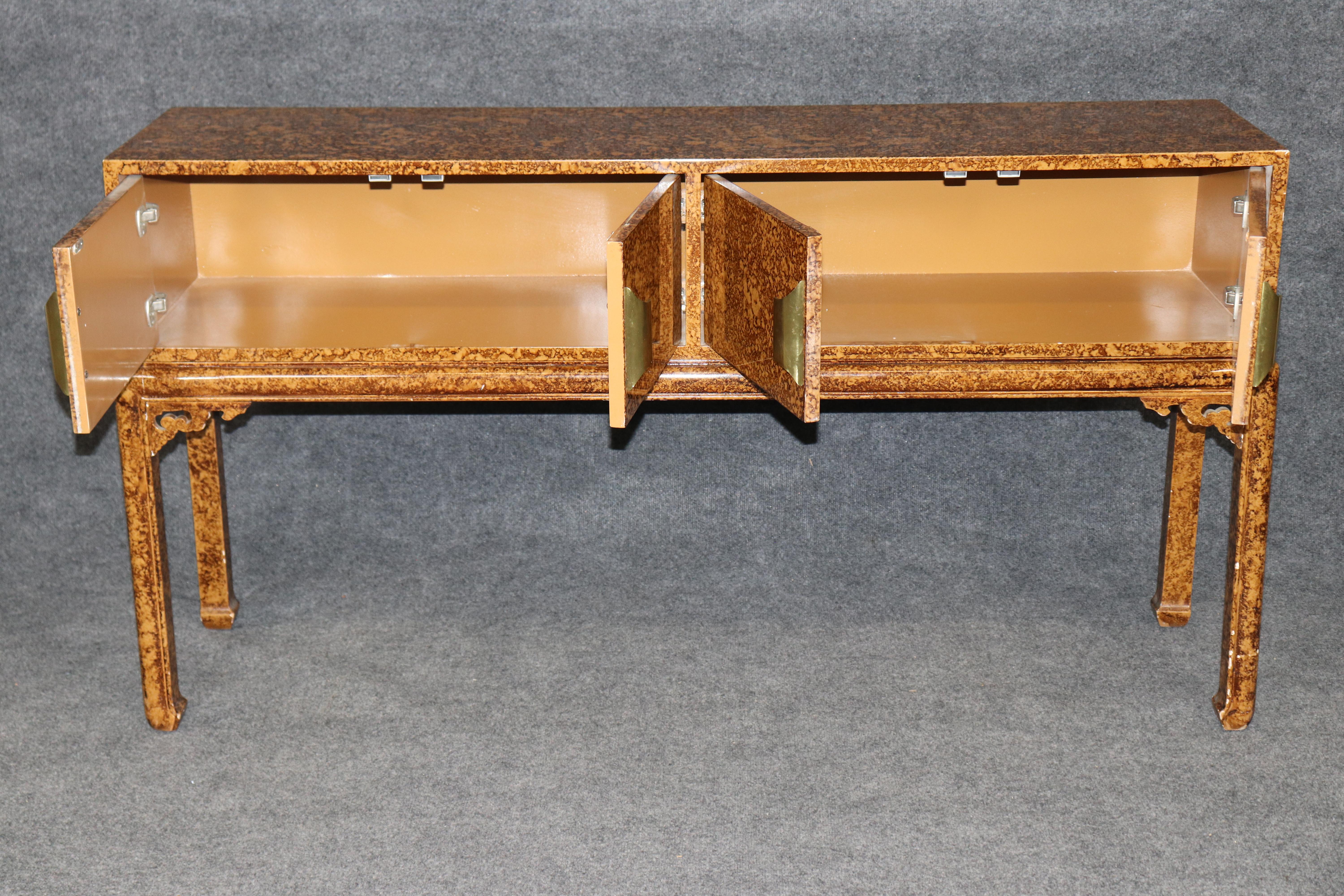Add timeless elegance to your home with this exquisite tortoise shell-painted sofa table, finished on all sides and crafted in the manner of Maison Jansen. This antique piece exudes French sophistication, featuring a richly textured tortoiseshell