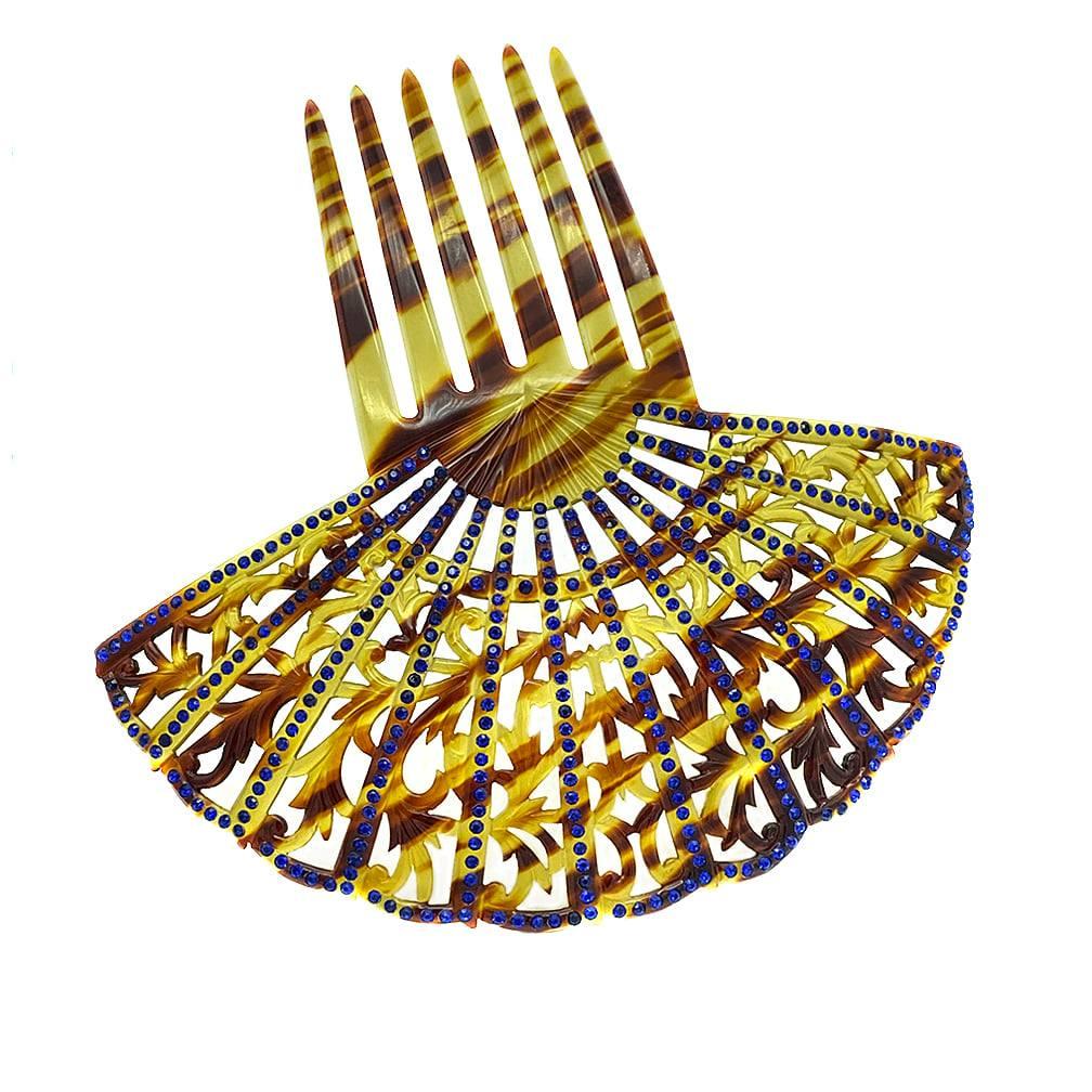 This is a faux tortoise shell peineta with six forks. This hair ornament, a large fan shaped decorative comb, has small blue rhinestones. Women in the Hispanic world usually worn them under a mantilla, or lace head covering, to church or special