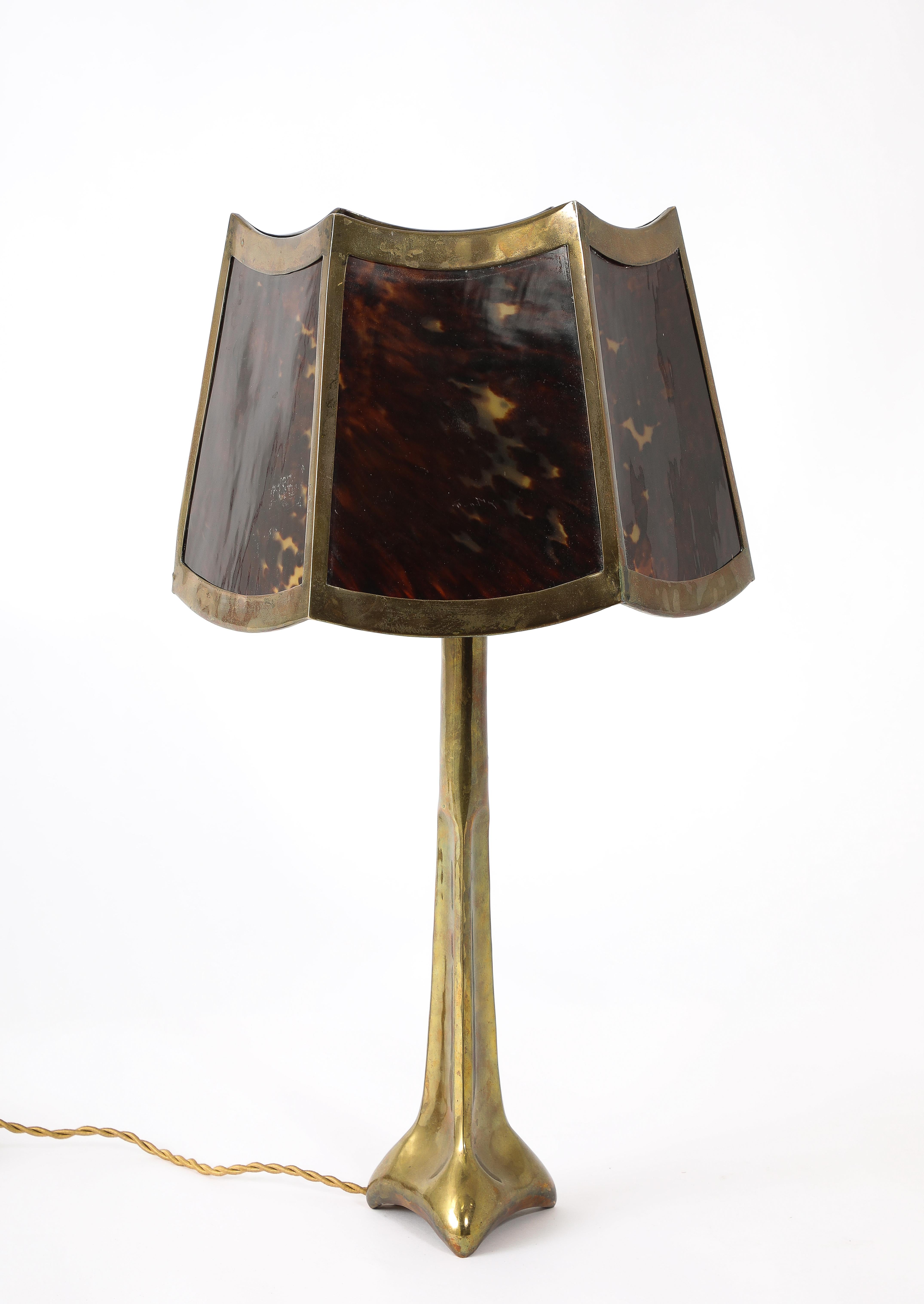 Artist made cast bronze table lamp with a bronze shade decorated with faux tortoise shell panels.