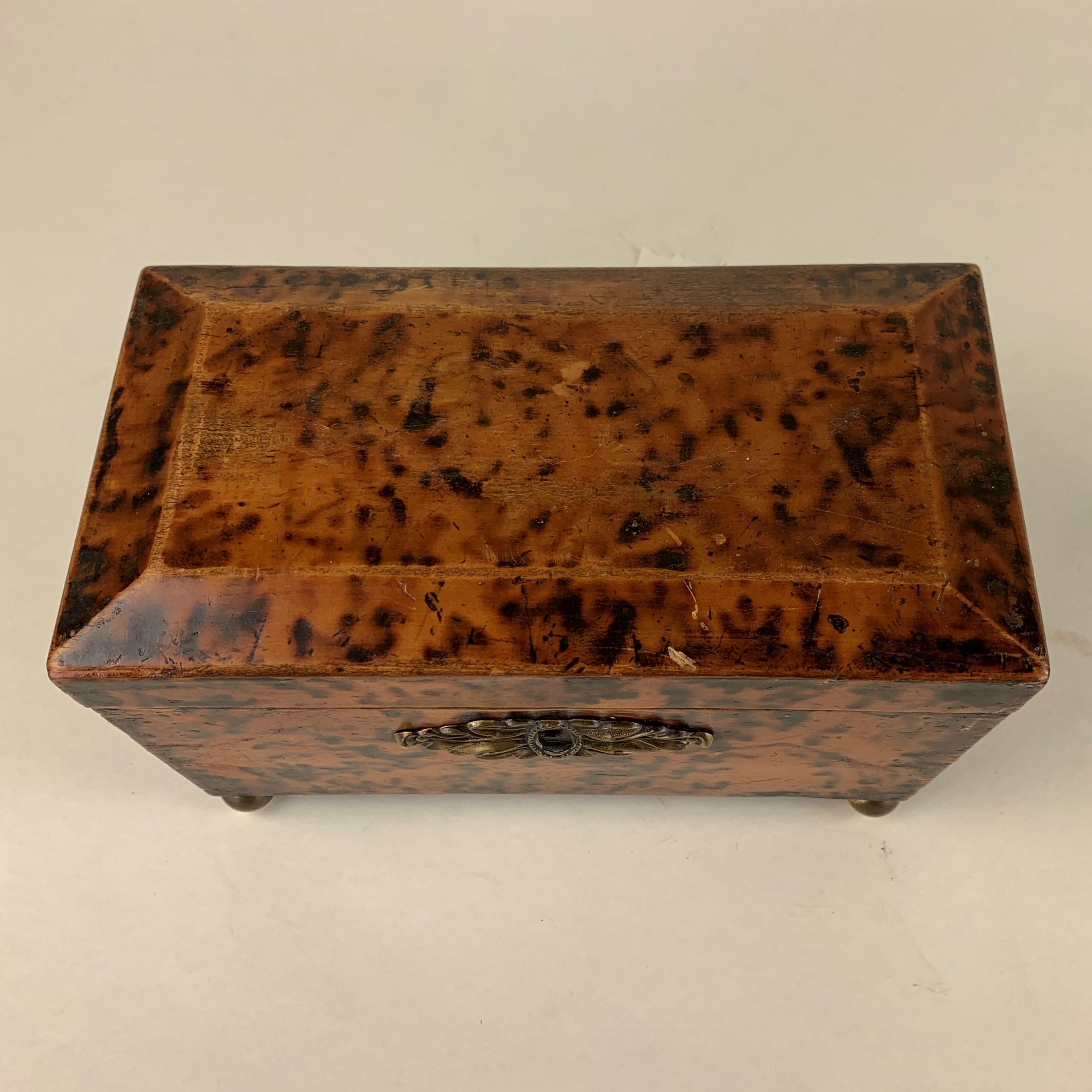 Unusual early 19th century simulated tortoiseshell two compartment rectangular tea caddy with cushion shaped lid and retaining the original inner lids. In reasonable condition for its age with only slight signs of wear and use.