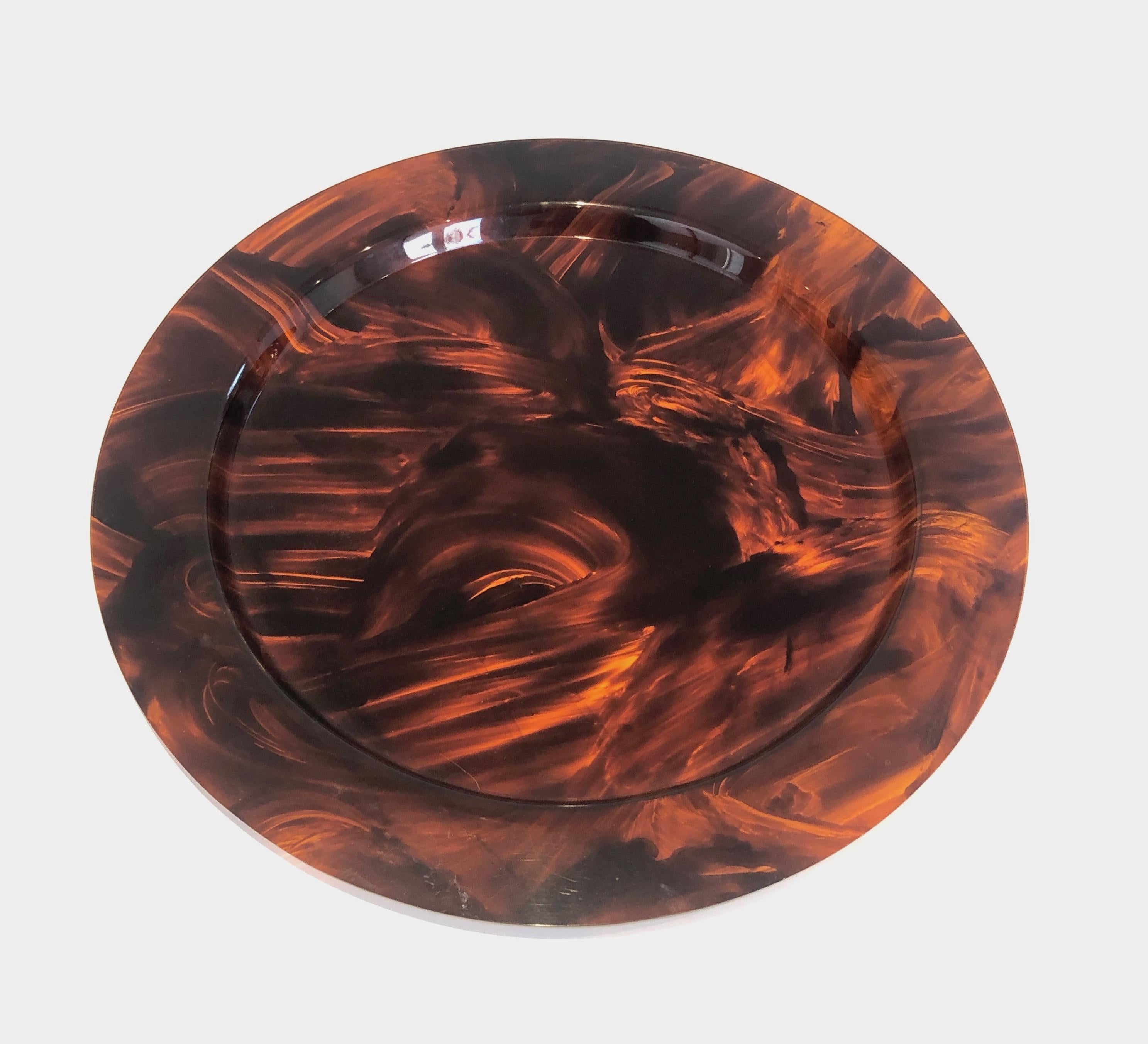 This faux turtle-shell round tray is made of lucite. This is a French work. Circa 1970.
