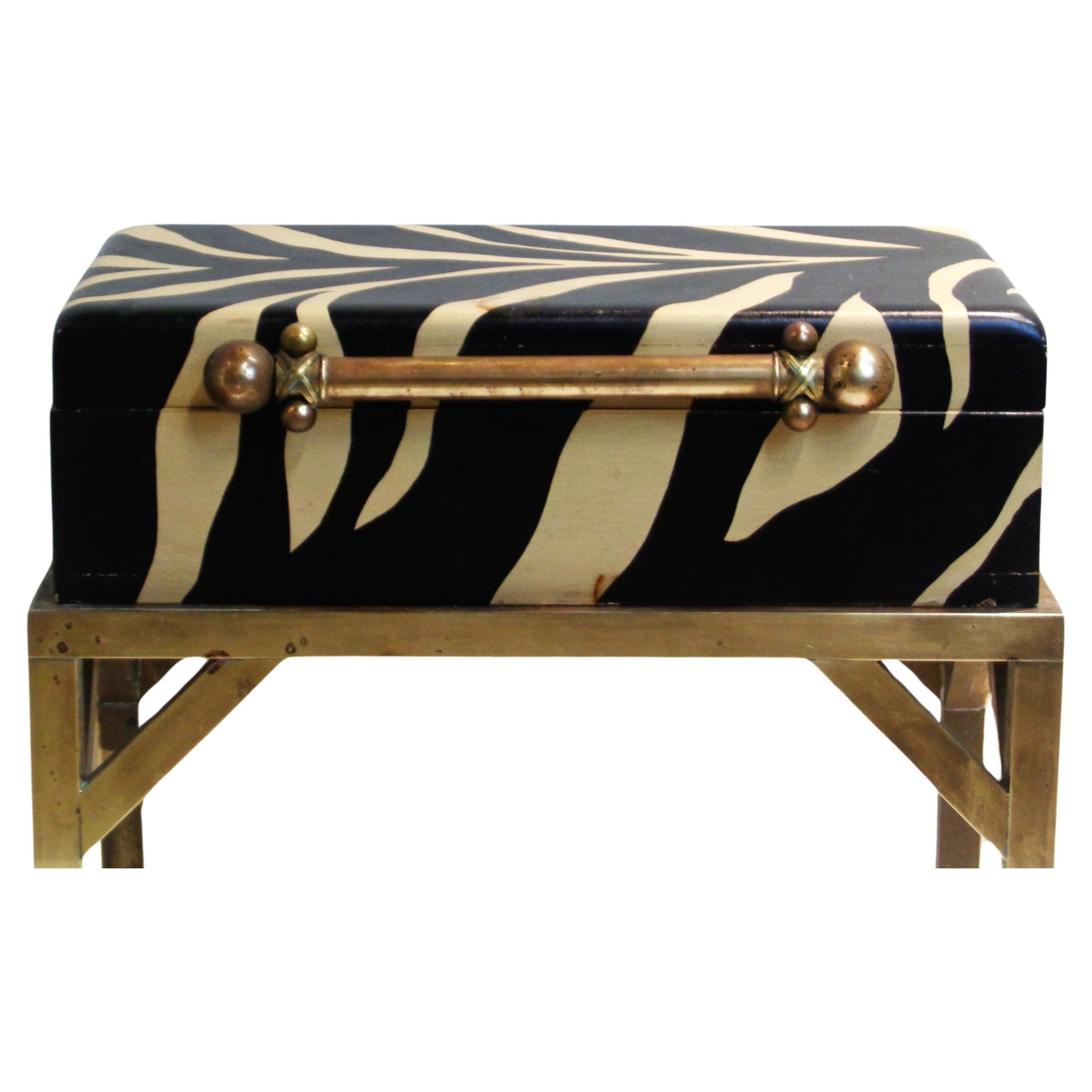  Faux zebra painted lidded wood box with a beautifully designed brass handle. Box sets into the original fitted brass table stand. Box on stand measures 19